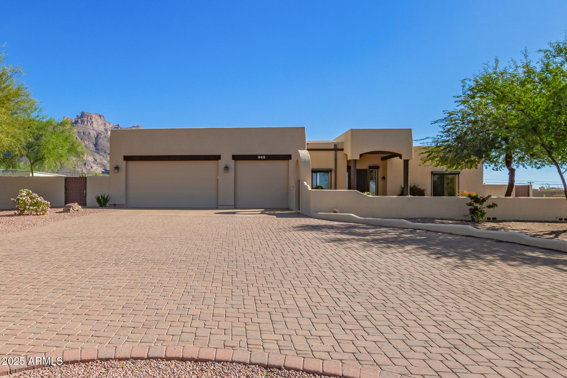 Seller offering $10,000 concessions to buyer for closing costs! Motivated Seller! Custom Territorial with Incredible Superstition Mountain Views with Cougar Shadow from your backyard!  The beautiful residence offers 4 beds, 2.5 baths, desert landscape, excellent curb appeal, and an oversized 3-car garage w/circular paver driveway. Awesome Smooth Pebble Tech Play Pool Heated and Cooled with Custom Slide, Electronic Security Sun Screens. All Situated on a HUGE 1.14-acre lot!  Interior exudes elegance with tall ceilings, abundant natural light, wood columns, Knotty Alder doors, archways, a neutral palette,  tile & soft carpet throughout. Open Floor Plan with a fireplace and a media center. The impressive kitchen showcases stainless steel appliances, granite counters & backsplash, a pantry, Knotty Alder cabinetry, recessed & pendant lighting, curved island w/breakfast bar large owner's suite has patio access and a spa-like bathroom with dual granite sinks, a jetted tub, a tiled shower, & a custom walk-in closet. Double-door 4th bedroom can be an office. Laundry room with a sink & storage closet. But the true highlight is the expansive backyard oasis, perfect for relaxation and entertaining! It features an extended paver-covered patio, a built-in BBQ grill, benches, and a cozy fire pit. At its heart lies a sparkling pool with a slide, offering year-round fun. Added perks include an RV gate and a storage shed. All set against a stunning mountain backdrop that adds beauty and tranquility to the outdoor space. What's not to like? See it! Love it! Live it!