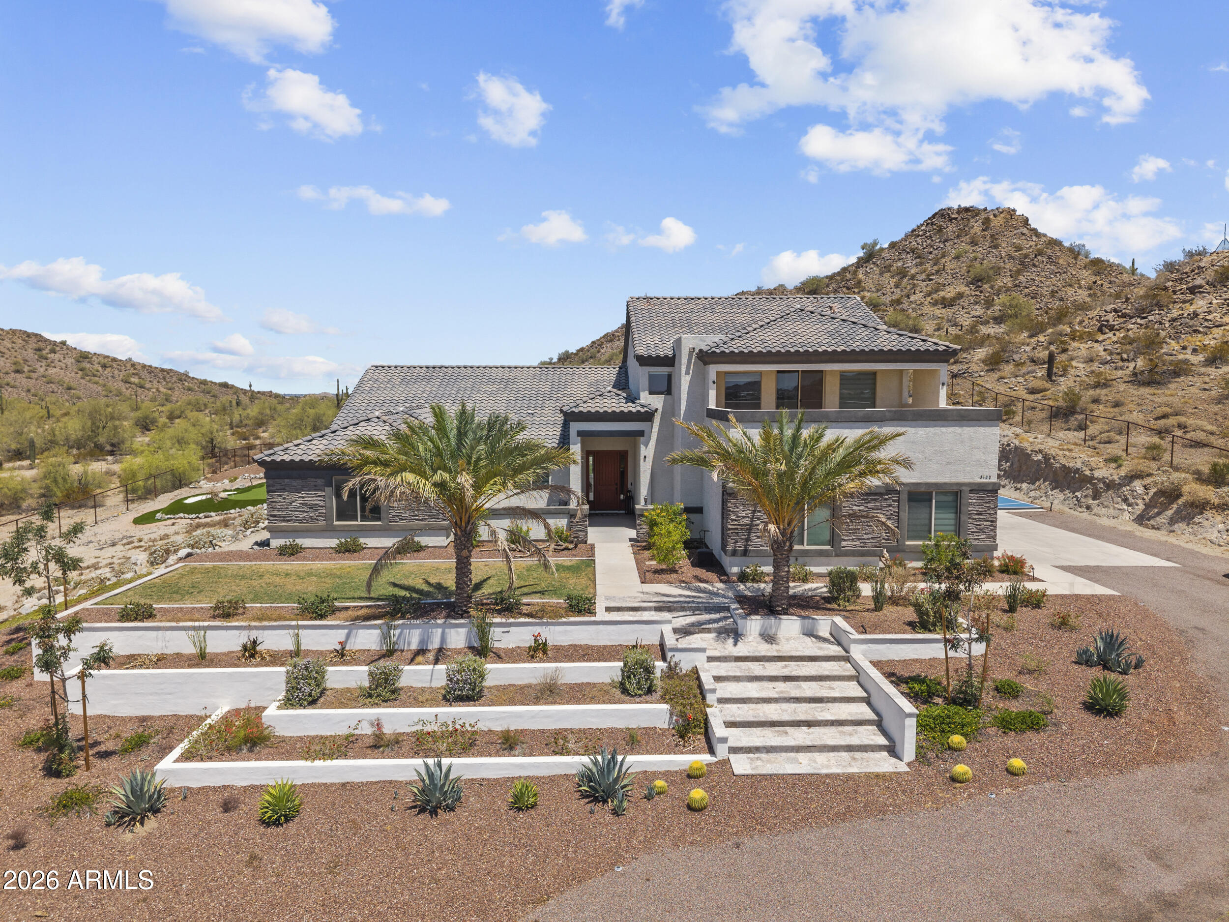 LOCATION & VIEWS! Experience elevated desert living on a rare 1.25-acre premium lot backing directly to the San Tan Mountain Preserve with truly unobstructed views. This property offers a level of privacy and natural beauty that is increasingly hard to find. 

Over $125k invested into extensive landscaping, including a sport court transforming the grounds into a fully usable, resort style setting that complements the surrounding desert. 

The home itself is expansive and versatile, featuring 6 bedrooms, 5 bathrooms, two separate great rooms, and a private ''mother-in-law'' suite--ideal for multi-generational living or long-term guests. Interior upgrades include granite countertops throughout, tile surrounds in all bathrooms, and a luxurious primary bath with dual shower heads and a rai feature. Smart home touches include electric blinds with remote and Alexa integration. Outdoor living is where this property truly stands apart. 

Enjoy a resort-style pool with water features, WiFi controls, multi-color lighting, a Baja step, and a 6-foot depth, all surrounded by travertine decking. Multiple balconies, including a covered second-story deck! Capture sweeping mountain and desert views in every direction. 

For those needing space and functionality, the property delivers with a 4 car garage featuring epoxy floors, built-in cabinetry, and a 50-amp plug for RV or EV use. There is also dedicated RV parking with an oversized gate, plus a fully fenced perimeter with an impressive 20 foot entry automatic gate.