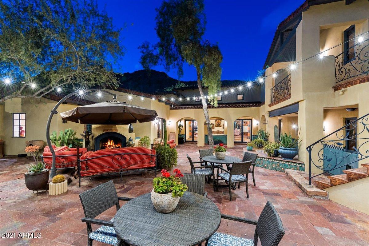Timeless old-world charm amidst Mummy Mountain boasting striking Camelback Mountain views is this Spanish Colonial Revival Architecture home designed by Nostdahl Liptack Architects. Sophisticated craftsmanship went into every detail of this remarkable home. Dramatic entry into the formal foyer opens to an intricate circular iron stairway leading into the whimsical living room with beamed cathedral ceiling. Spanish architectural elements throughout including embellished tiles, elaborate tile rug, baroque curves and arches, adorning stained glass windows and of course a cantina! Enchanting indoors and outdoors with a harmonious resort-style ambience. Indoor features include four bedrooms, five bathrooms, formal dining, quintessential kitchen, and an exercise room. Outdoor features consist of Private lighted tennis court, courtyards, balconies, fountains and a fireplace embracing a tranquil serenity, the epitome of Paradise Valley Living!