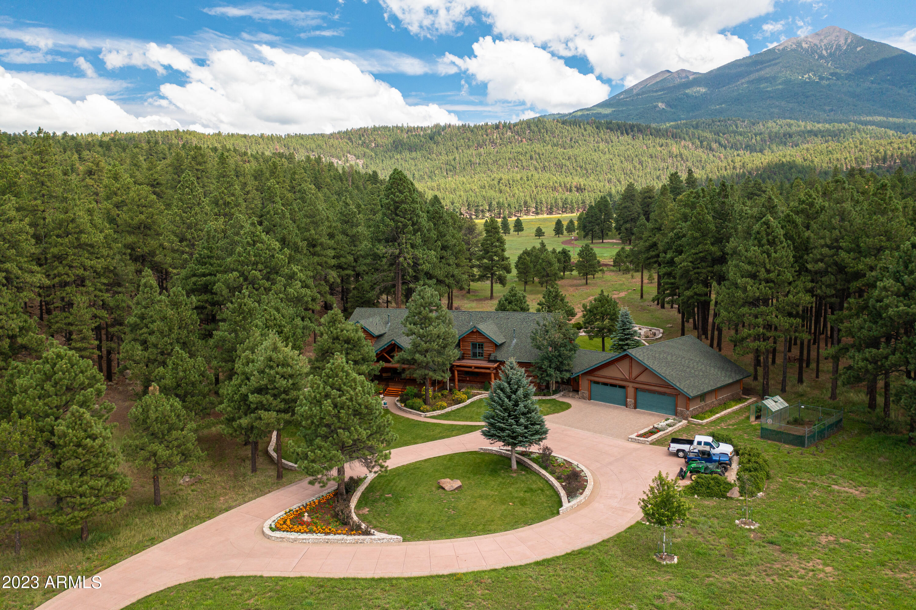 Luxurious Custom Log Cabin Estate in Snowbowl Ranch. Home was built with blue spruce logs from the mountain. Estate sits on over 12 acres and has breathtaking views of the San Francisco Peaks and is perfect for outdoor living and entertaining. There are 5 ensuite bedrooms, with a primary on the main floor and second floor. Gourmet kitchen features all stainless appliances, including 2 full size gas ranges, oversized kitchen island and walk in pantry. Living room has a double-sided fireplace, stunning mountain views and vaulted ceiling. There is a 4-car garage with workshop. Huge back yard with covered deck, water feature and best views of peaks in Northern Arizona. Come experience all this home and lot has to over, there is no other property like it in Flagstaff. There is also a large family room perfect for family gatherings to watch the game or your favorite movie. is a four-car garage for all your outdoor toys and a green house and enclosed garden area. The backyard includes a water feature, patio, gardens and the most Spectacular View of the Peaks. 9400 Snow Bowl Road is a Private 12 Acre Retreat located just 8 miles (15-minute drive) from downtown Flagstaff. There is no better place to enjoy the great outdoors then this home and backyard. The home and lot are Picture Perfect for a quiet night in or huge outdoor gathering. 2 wells on the subject property with one of them recently added. This unique property will not last long! Book your private showing today.