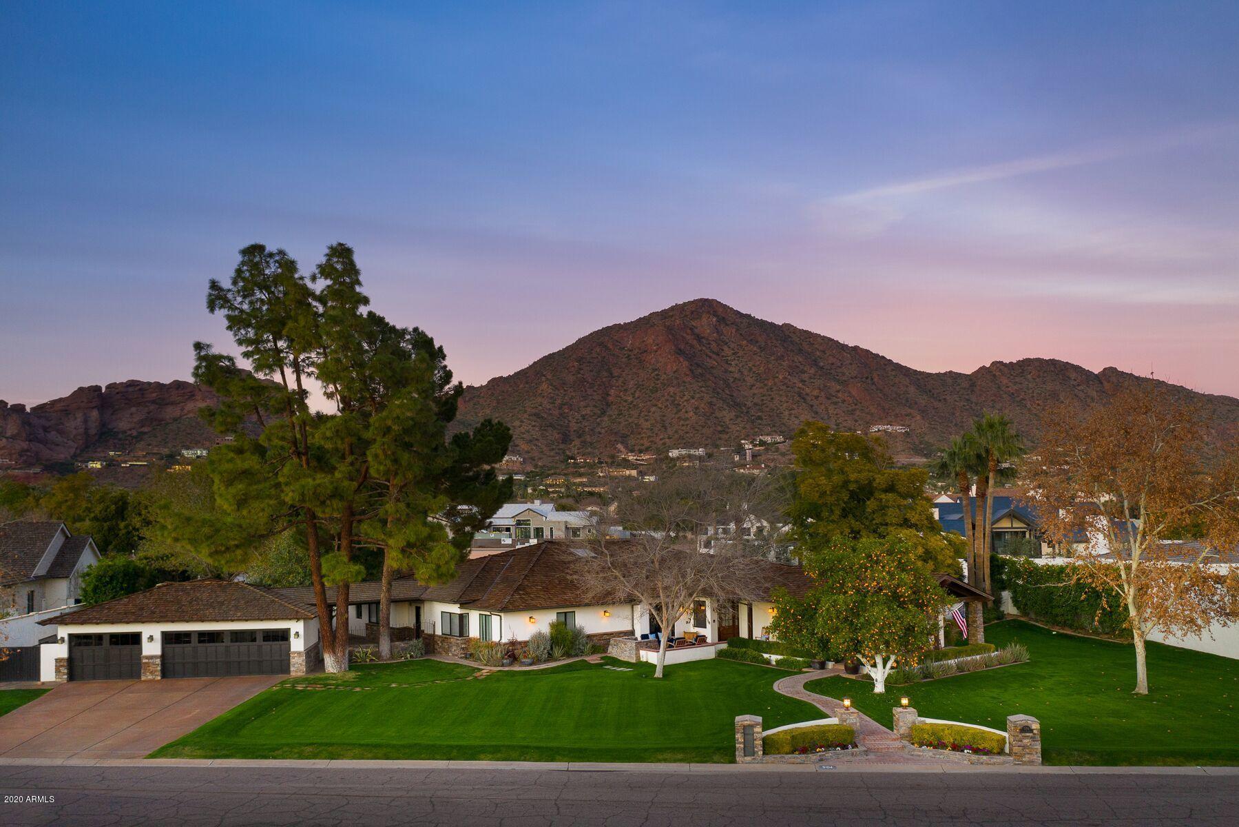 Rare opportunity to own nearly an acre on a north/south lot on one of the most idyllic streets in all of Arcadia! Let Camelback Mountain frame your windows from nearly every room! Open great room concept w/ loads of windows, natural light and every amenity you'd want in an Arcadia ranch! Featuring 4 bedrooms/4 baths +2 1/2 baths/playroom/ office/work out room and multiple outdoor entertaining areas! Remodeled with top of the line finish quality with wood flooring, granite and marble surfaces and high end fixtures. The real treat greets you outdoors with a resort like pool / spa opening up onto a spacious ramada with gas fireplace... Separate outdoor kitchen with gas bbq, wet bar, refrigerator and much more! Custom tree house, sport court and even a cute dog run for the pup!