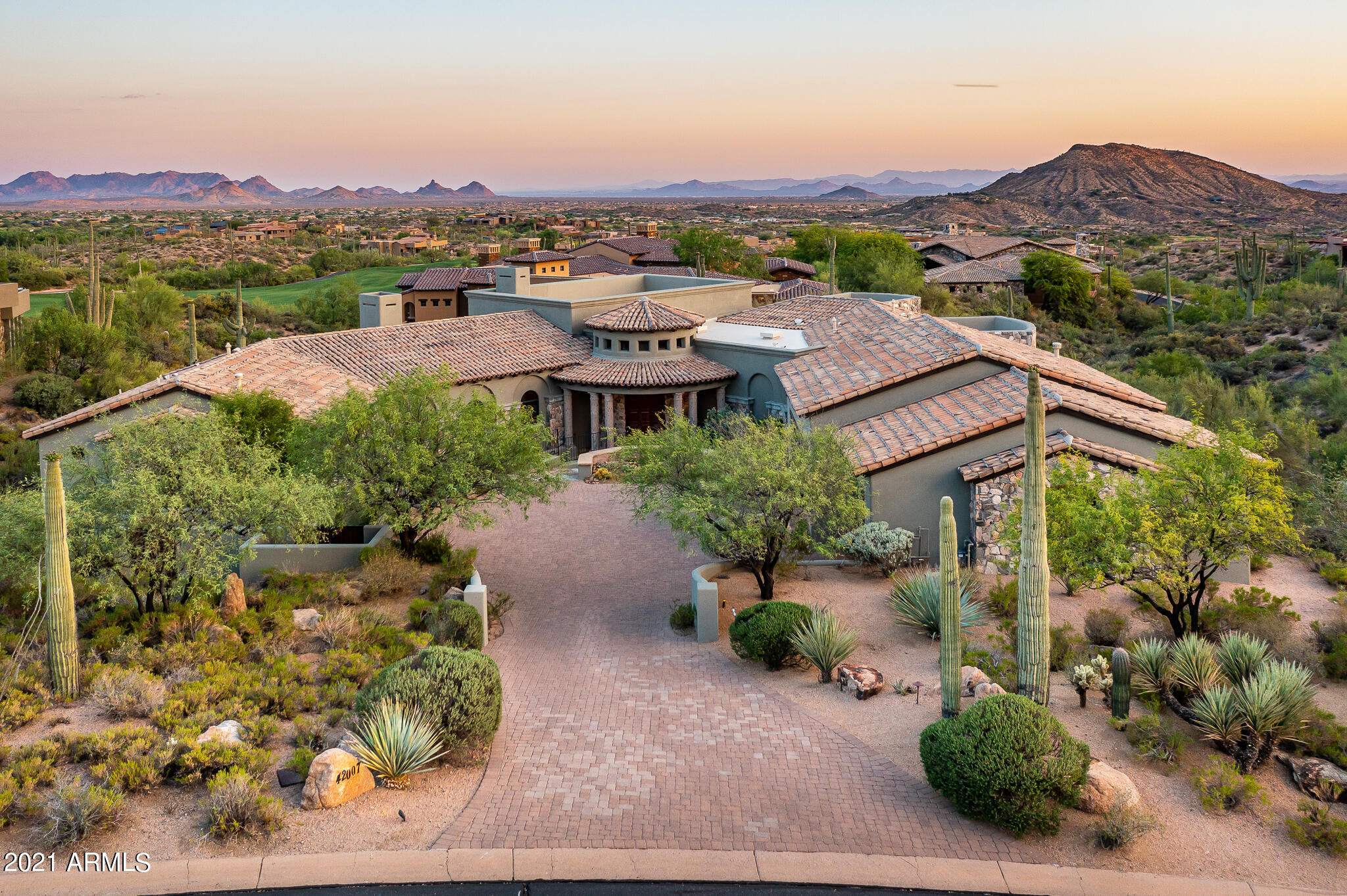 Elegant Desert Mountain Mediterranean estate with exceptional attention to detail.  Private, elevated corner lot in the Village of Saguaro Forest, looking out to Chiricahua's 7th fairway offers spectacular mountain, sunset, and city light views. Great room floor plan features 5BR/5.5BA, media/bonus room, dining room, and separate entrance to 2 room casita.    Chefs kitchen features natural stone and wood, granite counter tops, Viking appliances, and 350+ bottle wine room.  Kitchen and great room open to backyard patio oasis, showcasing negative edge pool, spa, built-in BBQ, and fire pit. Eco-friendly green construction with hand plastered American clay walls and exposed beams highlight the exceptional craftsmanship in this home.Furniture available under separate Bill of Sale. Furniture available under separate agreement.  Desert Mountain golf membership available from owner but not included in price with Club approval.