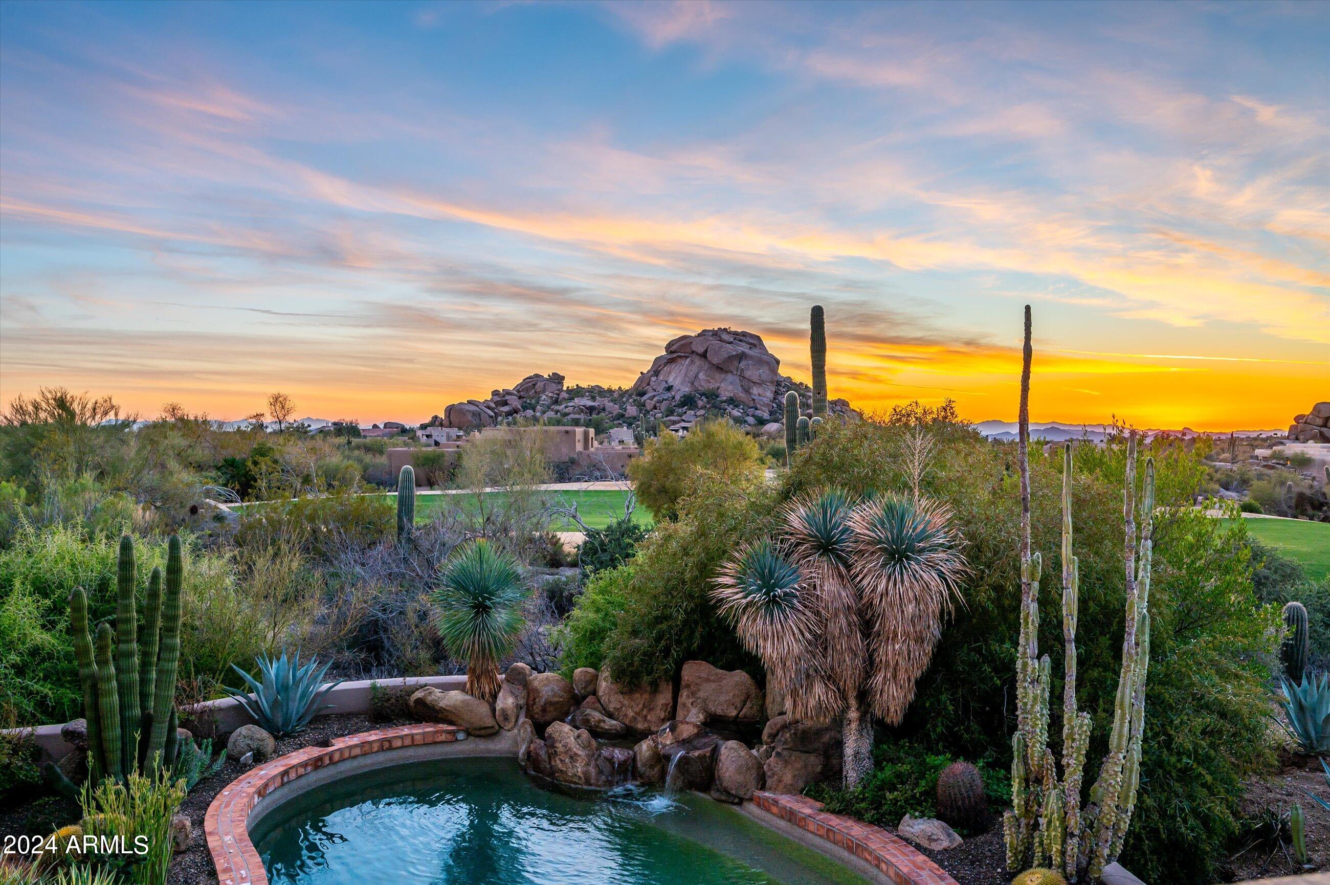 This exceptional property boasts an impressive blend of privacy and breathtaking views of the golf course, sunsets, Black Mountain and boulders. The Southwest charm and character abound throughout with artistic touches and a unique ceiling in every room. Additional features include an expansive great room with floor to ceiling windows, bright eat-in kitchen with cozy sitting area and fireplace and a private primary suite with patio access and spacious walk-in closet. Additionally, there are two guest suites in a separate wing. Upstairs offers a spectacular deck to enjoy the expansive views and additional guest suite/office. A backyard oasis showcases the lush desert landscape, spa, pool with water feature, fireplace and built-in BBQ