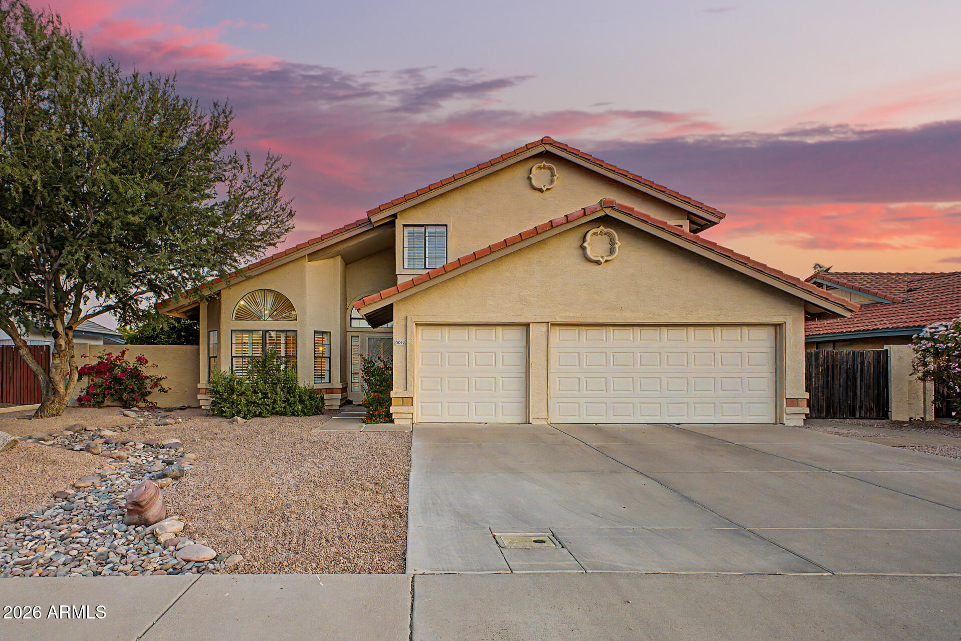 Beautifully updated home in Alta Mesa with exceptional curb appeal, RV gate, and 3-car garage with built-in storage cabinets. Inside, you'll find soaring vaulted ceilings, plantation shutters, upgraded 6-panel interior doors, recessed lighting, hardwood flooring throughout the main living areas, and a charming brick-accented gas fireplace in the family room.

The remodeled kitchen features Quartz countertops, subway tile backsplash, stainless steel appliances, breakfast bar seating, custom cabinetry with pull-out drawers, and ample prep space. Double French doors open to the backyard, creating seamless indoor-outdoor living. The spacious downstairs primary suite features upgraded flooring, mirrored walk-in closet doors, and a beautifully renovated ensuite with dual sinks, a freestanding soaking tub, a glass-enclosed shower, and a walk-in closet. Bathrooms were tastefully remodeled in 2021, and the home also includes a newer 2025 A/C and built-in vacuum system for added convenience.

Upstairs features a versatile loft, two secondary bedrooms, and an updated bathroom with dual sinks. Step outside to a private backyard complete with a full-length covered patio with Mexican tile flooring, a tranquil fountain, built-in cement benches, and mature citrus trees, perfect for relaxing or entertaining. A must-see home!