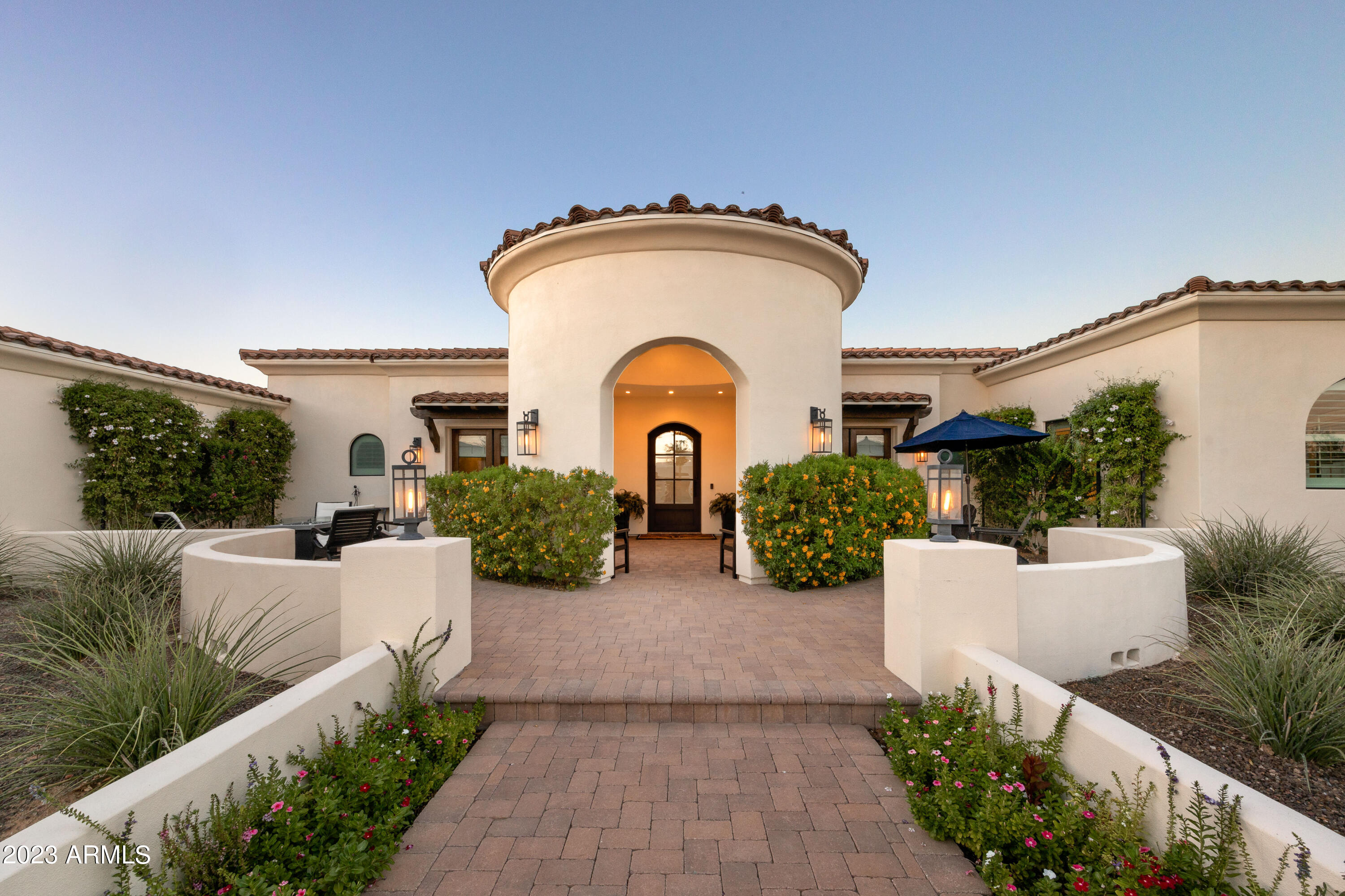 This stunning 2014-built Santa Barbara-inspired residence has recently been updated to offer the pinnacle of luxurious desert living. With 5,390 square feet of exquisite design and thoughtful features, this property is a true gem. The well-appointed living spaces flow seamlessly from one room to the next, creating an inviting atmosphere for gatherings with family and friends. The generous living room, complete with a cozy fireplace, is the perfect place to relax and unwind. One of the highlights of this Paradise Valley paradise is the exceptional outdoor living area, featuring a fantastic ramada with a built-in Argentina grill, a Green Egg smoker, and a convenient sink, making it the ideal spot for al fresco dining. With 5 bedrooms, 5.5 bathrooms and den or office, including a luxurious master suite, there's plenty of room for everyone in the family. The master retreat is a true sanctuary, featuring a spa-like en-suite bathroom and access to a private patio, perfect for enjoying your morning coffee. Situated on a spacious lot, this property offers plenty of room for outdoor activities, whether you want to lounge by the sparkling pool, play a game of catch on the lush lawn, or simply soak in the Arizona sunshine. The location couldn't be more ideal. Paradise Valley is known for its upscale amenities and stunning desert landscapes, making it one of the most sought-after communities in the Phoenix area. You'll have easy access to world-class golf courses, top-rated schools, fine dining, and high-end shopping. Don't miss this opportunity to make this Santa Barbara-inspired masterpiece your forever home. Schedule a private showing today and experience the magic of Paradise Valley living at its finest!