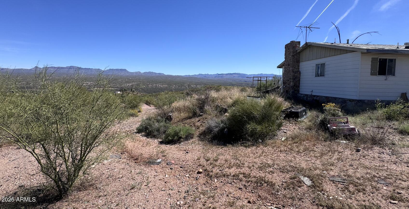 THE VIEW ALONE IS WORTH IT!!  Land backs up to Government Land!!!! 2 Bedroom 1 Bath on over 3.472 Acres. There is a separate 1 car garage and Ready for your Farm Animals! WELL IS ALREADY DUG (pump is broken), and Electricity is on the side of the manufactured home with a fireplace!