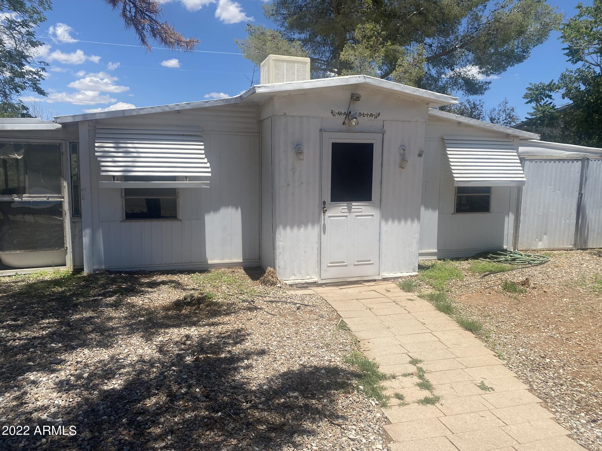 CALLING ALL INVESTORS-
This triple wide has 3 great sized bedrooms 1 full bath and jack/jill 1/2 bath- Attached Az room and garage that run on both sides of  the entire length of the home!! Fully fenced with pedestrian gate and RV gate.
No HOA and you own the land-
Buyer to verify square footage
This home is being sold-as where-is
