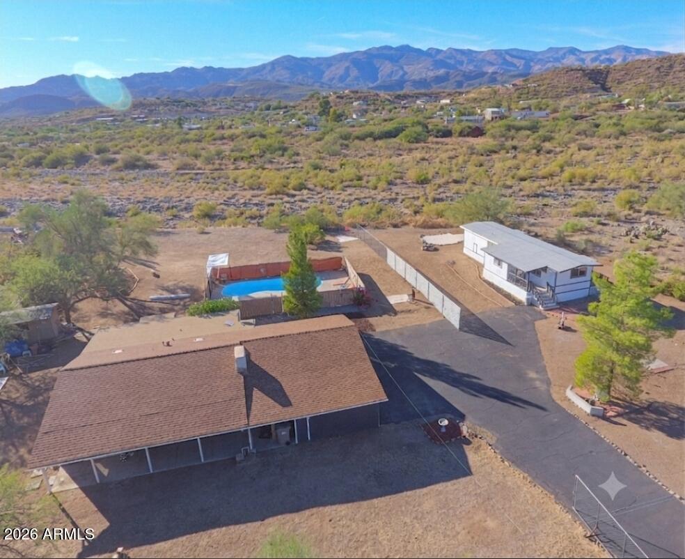 Looking for a unique lifestyle change? This property offers a rare ''two-for-one'' opportunity on a spacious, beautiful acre in Black Canyon City. With each home operating on its own private well, septic system, and power, it's perfect for multi-generational living, an income-producing rental, or dedicated workspace.  The main home is a 2/2 and thoughtfully renovated and is completely move-in ready. Outside, you'll find an amazing sparkling pool.  The back of the property borders a scenic wash, offering both private and unobstructed, breathtaking sunset views.  The second home is a 2/1 and is a perfect hunting hub, extra income, or in-law suite!  Beyond the existing setup, there is plenty of room to expand and add your own custom features.