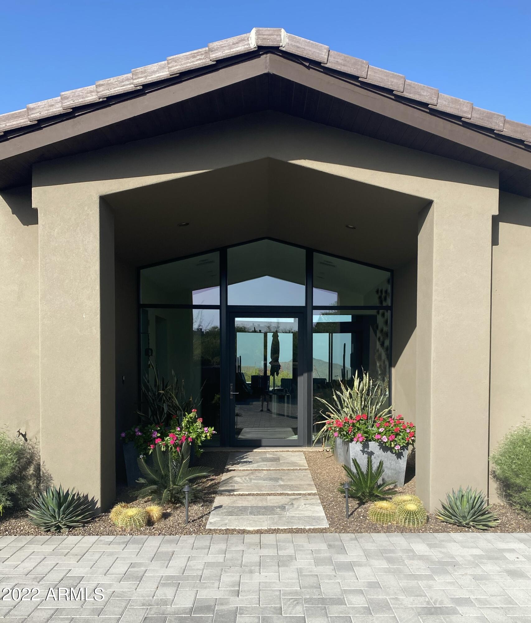 Beautiful Soft Contemporary with elevated mountain and sunset views.  Full glass entry leads to your spectacular see through 16 Foot great room ceilings that continue to a breathtaking rear glass system. On to outdoor privacy, those jaw dropping views, pool, spa and bbq. Massive veranda protects seating and eating areas for continued comfort. Large rooms throughout include Dual Master suites, luxury kitchen and assorted entertainment areas. Warm use of colors makes you feel like your at home when you arrive. Fully landscaped / lighted front and rear.  Golf Membership to the Desert Mountain Club Available with approved application.