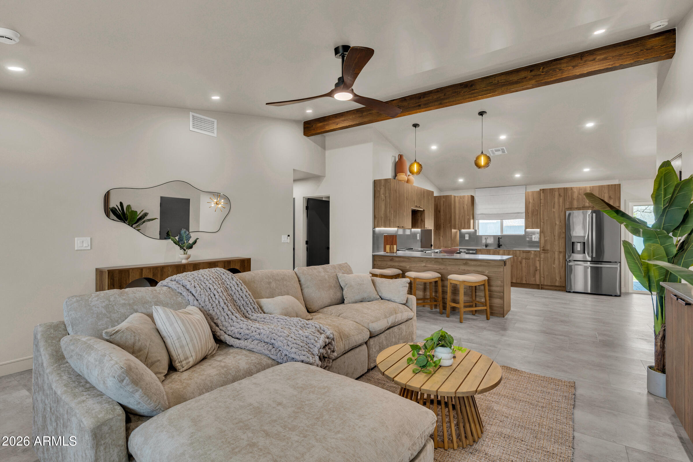 Welcome to 1427 N. McAllister Ave -- a rare opportunity to own a completely reimagined Tempe residence where virtually everything has been rebuilt from the ground up with intention, craftsmanship, and a long-term mindset. This is not a renovation. This is a full transformation designed for buyers who value exceptional design, an unbeatable location, and true turnkey living. Positioned on an oversized 11,500+ sq. ft. cul-de-sac lot with NO HOA, this one-of-a-kind 4-bedroom, 2-bath home sits along the coveted Tempe/Scottsdale border--just steps from Papago Park hiking trails, moments from a nearby dog park, and only 10 minutes to Old Town Scottsdale's dining, shopping, and nightlife. Inside, soaring 12-foot raised ceilings with exposed beams create an immediate sense of scale. Unlike typical remodels, every major system was replaced to create lasting value and peace of mind: new 5-ton HVAC with all-new ductwork, R-38 spray foam insulation, full electrical rewire, all-new underground plumbing, energy-efficient windows, and more.
The designer kitchen serves as the centerpiece of the home with Grigio Vesuvio quartz carried seamlessly up the backsplash, under-cabinet lighting, a full GE appliance suite, reverse osmosis system, and custom walnut hardware throughout.

Retreat to spa-inspired bathrooms featuring designer tile, oversized walk-in showers, and Delta matte black fixtures that deliver a luxury hotel feel every day. Every bedroom includes custom closet systems, highlighted by a beautifully designed primary walk-in closet.

Outside, the oversized backyard creates a private resort experience with three distinct outdoor living spaces, a fully rebuilt pool finished in PebbleTec with color-changing LED lighting, custom pergola, Belmont pavers, custom iron fencing, fresh landscaping with irrigation, and maintenance-free solar landscape lighting.

Additional details include Kerf doors, handcrafted Zellige hallway tile, 5-inch custom baseboards, Level 5 smooth drywall finish, zebra blinds, and a striking Sherwin-Williams Urbane Bronze and Mushroom exterior palette.
Fully turnkey. Completely rebuilt. Designed to deliver location, lifestyle, and long-term value--this is Tempe living redefined.The custom spa-like bathrooms are a true retreat -- luxurious walk-in showers with designer tile, Delta matte black fixtures that feel five-star from the first use. Every bedroom features a custom closet system, with a large walk-in in the primary suite that is as functional as it is beautiful. Outside, the massive private lot delivers three distinct outdoor zones: a fully rebuilt pool with fresh Pebble Tec and color-changing LED lighting, a custom pergola, Belmont pavers, custom iron fencing, fresh landscaping with full irrigation, and no-maintenance solar landscape lighting throughout.
Kerf doors, 5" custom baseboards, 90/10 level 5 finish drywall, Zelige handcrafted hallway tile, zebra blinds, and Sherwin Williams Urbane Bronze and Mushroom exterior complete a home where nothing was overlooked. Move-in ready. Built to last. This is Tempe living at its finest!