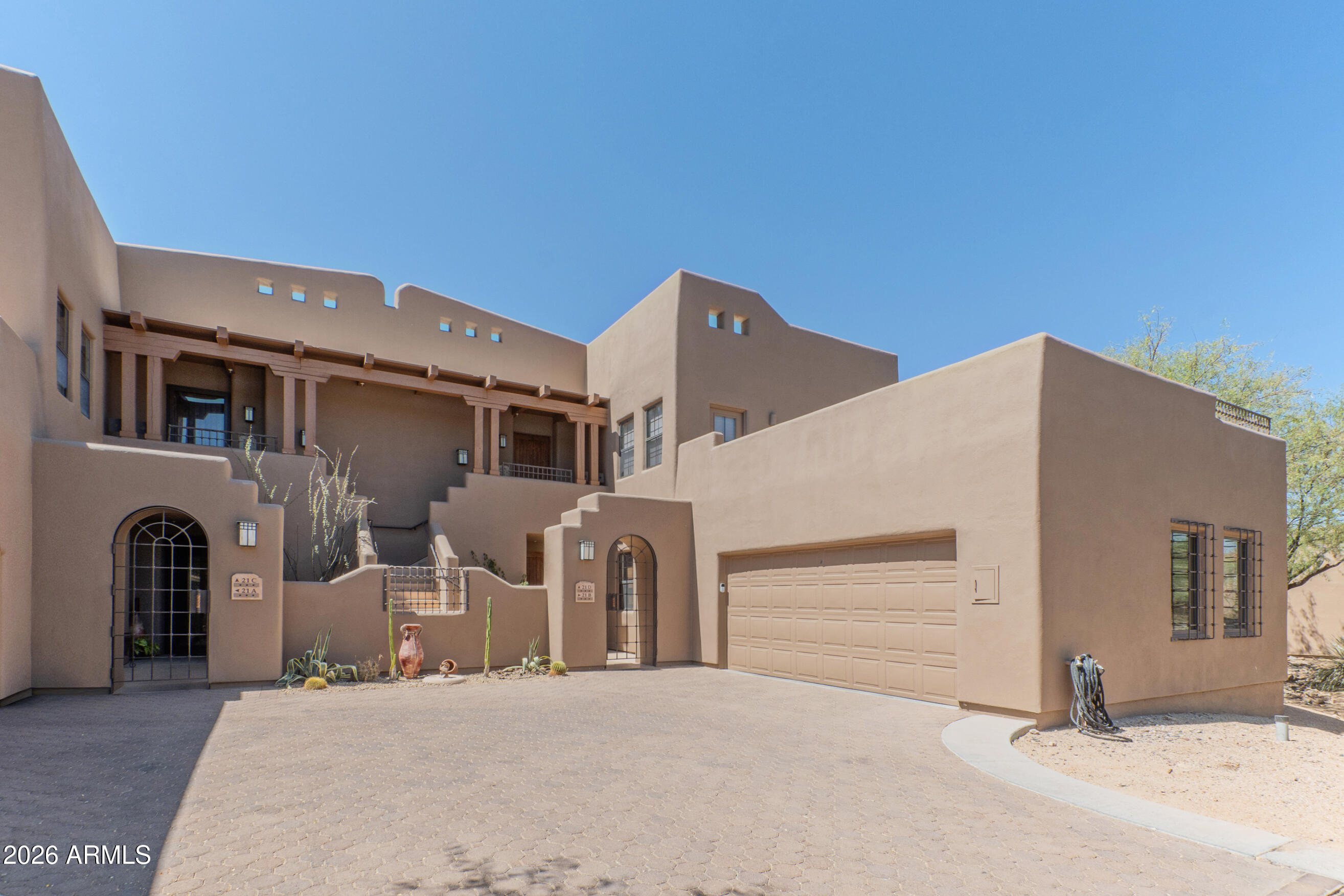 Beautifully remodeled GROUND LEVEL unit features a FULLY separate jr. suite with its own kitchen and bath. Ideal for guests or rental income with 30-day minimum rentals and is leased through 4/27/27, providing immediate income for the new owner. The main residence offers a large open-concept floor plan with flexible living and dining areas, a cozy fireplace, and a remodeled kitchen featuring granite countertops, a deep soapstone sink, stainless steel appliances and breakfast bar. Enjoy a private south-facing patio accessed from the living room and the spacious primary suite. Primary has a walk-in closet, ensuite bath with jetted tub w/ separate shower. A second full bath with walk-in shower provides added convenience for main suite residents or guests. This gated community has a lovely pool, spa and clubhouse with full kitchen and several areas for lounging or visiting with neighbors. Worry free living with HOA covering exterior maintenance as well as roof repair and replacement. Close to the fabulous shops and restaurants in Carefee and Cave Creek and steps from Civana Resort and Spa. This well priced ground level unit with immeditate rental income will not last long! Please note that the junior suite will only be available to be seen after execution of a contract.