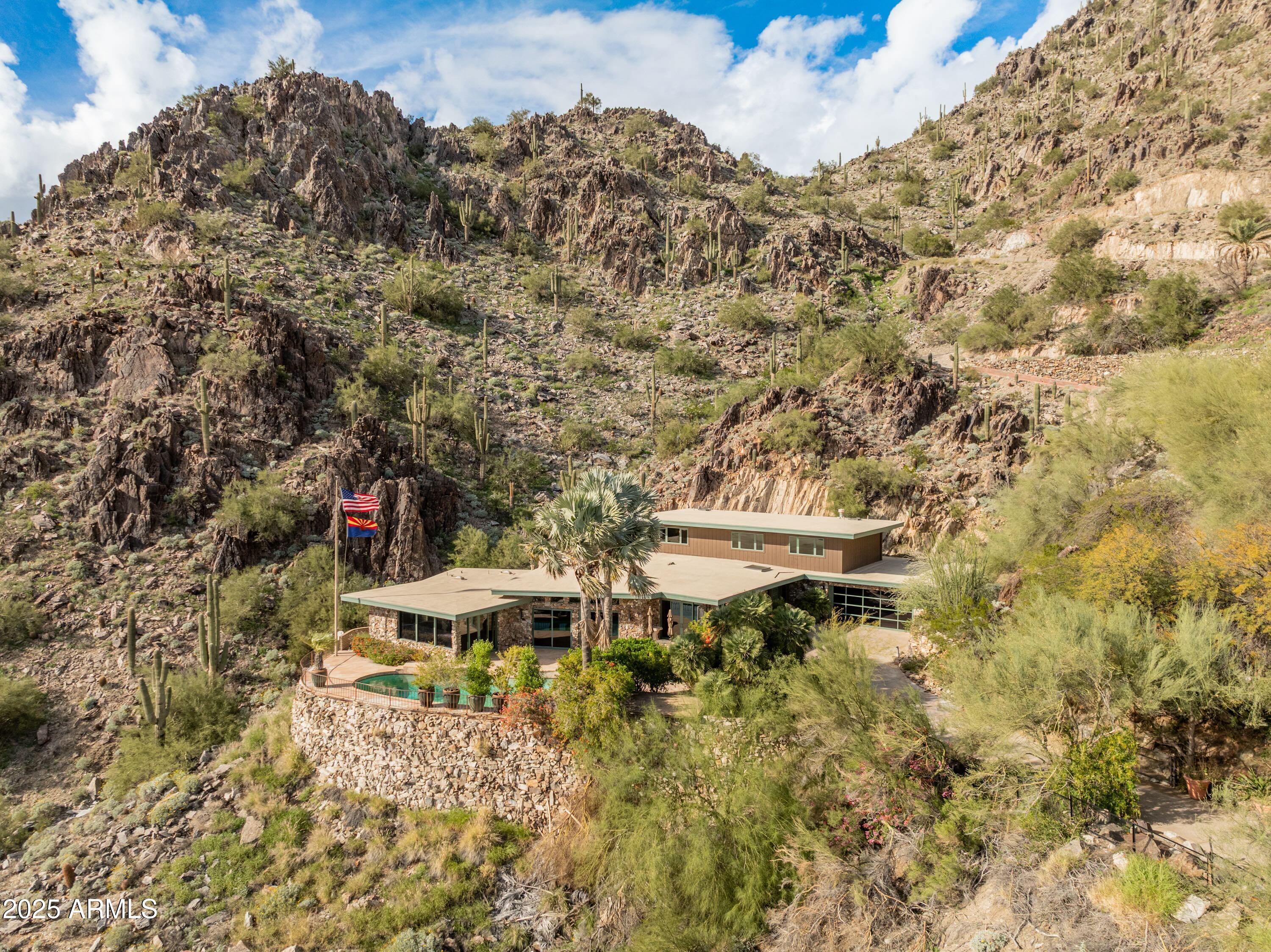 Casa High Cliff was professionally designed by Casa Bella Interiors, constructed by Dave Hansen, & featured in Phoenix Home & Garden (''Stone & Steel'') -- A stunning privately gated 2.3+ acre mid-century modern estate 1,750 ft up & carved into the mountainside on Highcliff Drive backing to the Phoenix Mountain Preserve - one of only 4 homes sitting on this elevated and premier section of Clearwater Hills. Open kitchen design w/ Sub Zero & Viking appliances & wine fridge. There are many possibilities - from a light or full remodeling of the current (very livable) home or building your new hillside resort masterpiece. Views, privacy, and exclusivity at your fingertips!