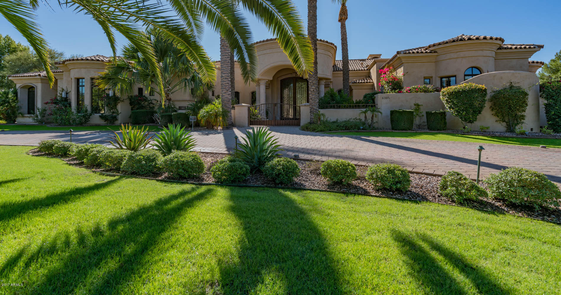 Magnificent home with gorgeous stone and wood flooring throughout. You will fall in love at first sight when you enter in to this stunning living/dining rm. with beautiful wet bar and walk in wine cellar. Pristine, newly updated chefs kitchen. A chefs dream come true with 2 islands, huge double subzero, built in Miele expresso maker, butlers pantry. Creston system controls lights, door, pool lights and much more. Family room french door opens into wall.  Spectacular master bdrm. and master bath. An additional Miele expresso maker and refrig. Huge walk in closets with washer and dryer in hers. Gated motor court for private entry to 4 garages. Beautiful office with blt. ins. Resort backyd with gorgeous pool and spa and guest casita. Pool completely redone in 2016. This home is very special.