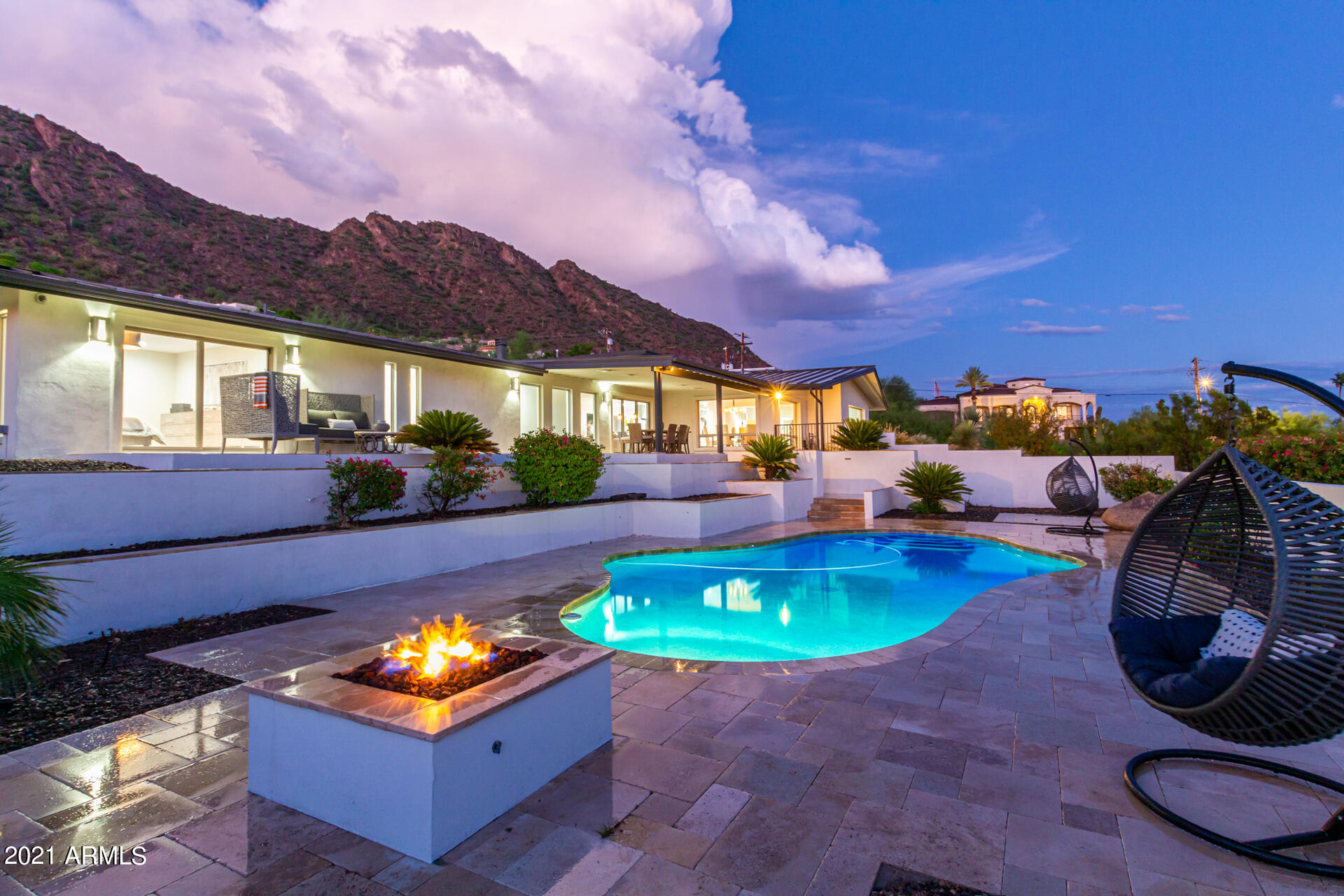 Views Views! Enjoy city lights & Mountain Views from this chic contemporary renovated home situated on the south side of Camelback Mountain! This stunning home has 4 bedrooms 3.5 bath, theater room complete w/ large projector, 3 car garage complete w/ a tesla charger, 2 driveways, & features a guest casita upstairs w/ private access all located on just under an acre with low maintenance landscape! Beautiful kitchen features new quartz countertops, Sub Zero refrigerator, Wolf appliances, & wine refrigerator. Upgrades include new floors, new interior & exterior paint, new lighting, whole home entertainement system w/Crestron control, Sonos, Crestron door locks, surround sound & speakers inside & out, artificial turf & pavers, new drip system, firepit, & sparkling pool overlooking the city! Stunning views over Arcadia, Papago, Scottsdale, & Downtown Phoenix. All of this and so much more plus centrally located near all the hots spots that Arcadia, Scottsdale and Paradise Valley have to offer!! All furniture and gym equipment available for sale. Casita/Flex Gym has reinforced ceiling for weights and treadmill running.