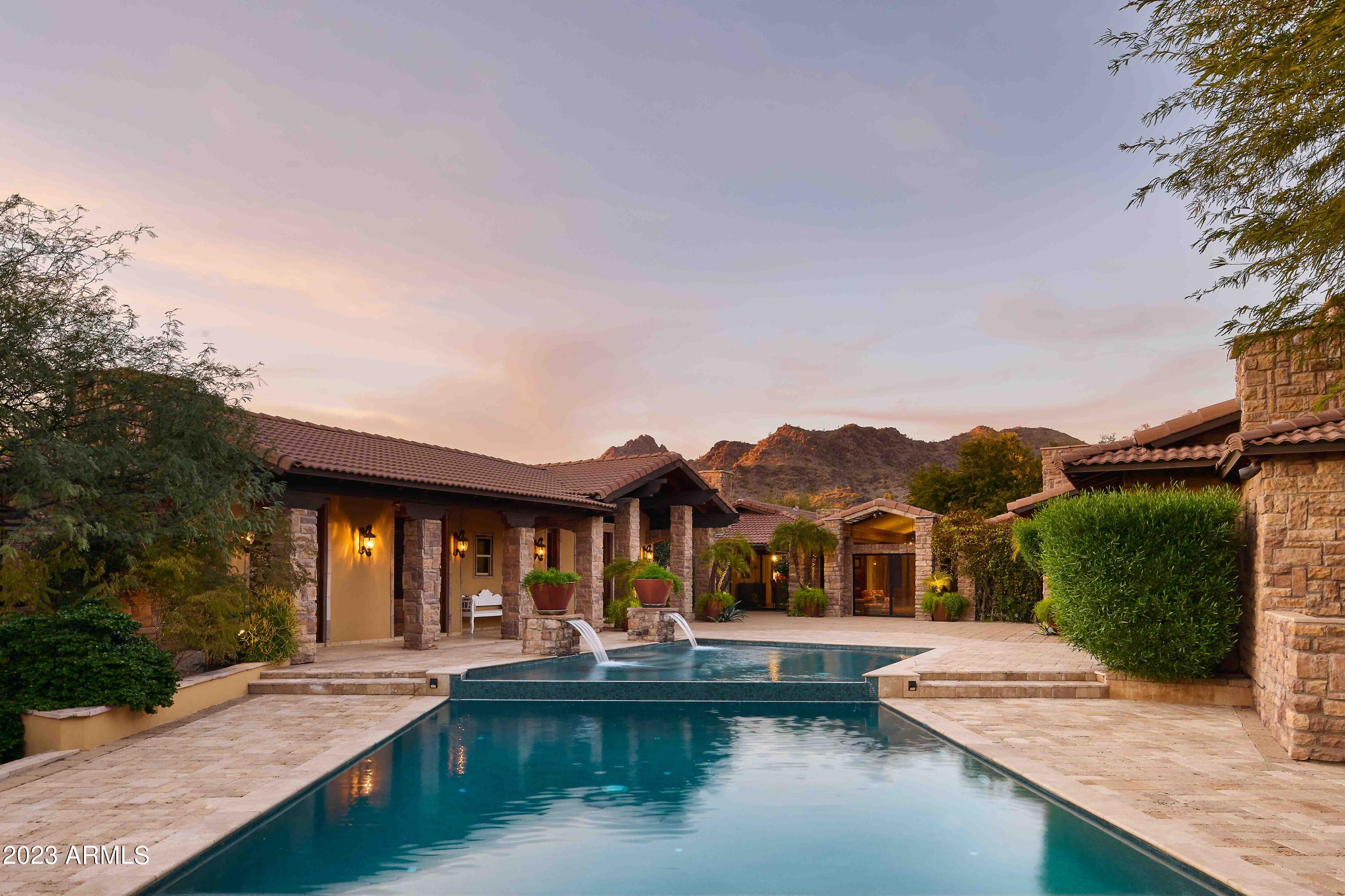 GORGEOUSLY REMODELED! This Oasis in the Desert was rebuilt in 2009 and significantly updated in 2021 to include  a true Chef's Kitchen with the highest quality custom cabinetry & detail, plus all new Trane variable speed HVACs. Epic entertaining in mind, a massive, automated sliding wall of glass leads to a show stopping covered outdoor kitchen/BBQ area. Also featuring an extremely RARE separate 2-bed, 2-bath, full KITCHEN/LIVING Guest Villa with multiple private patios, indoor & outdoor gas fireplaces, & stunning views of the Preserve. The horseshoe design surrounding the custom Pool offers total privacy. Ideal LOCATION, just minutes from the 37,000 acre Mtn Preserve, the 51 Freeway, Downtown PHX, and of course the Biltmore Fashion Square featuring the... new LIFETIME athletic club/spa, numerous shops, restaurants, & entertainment venues.