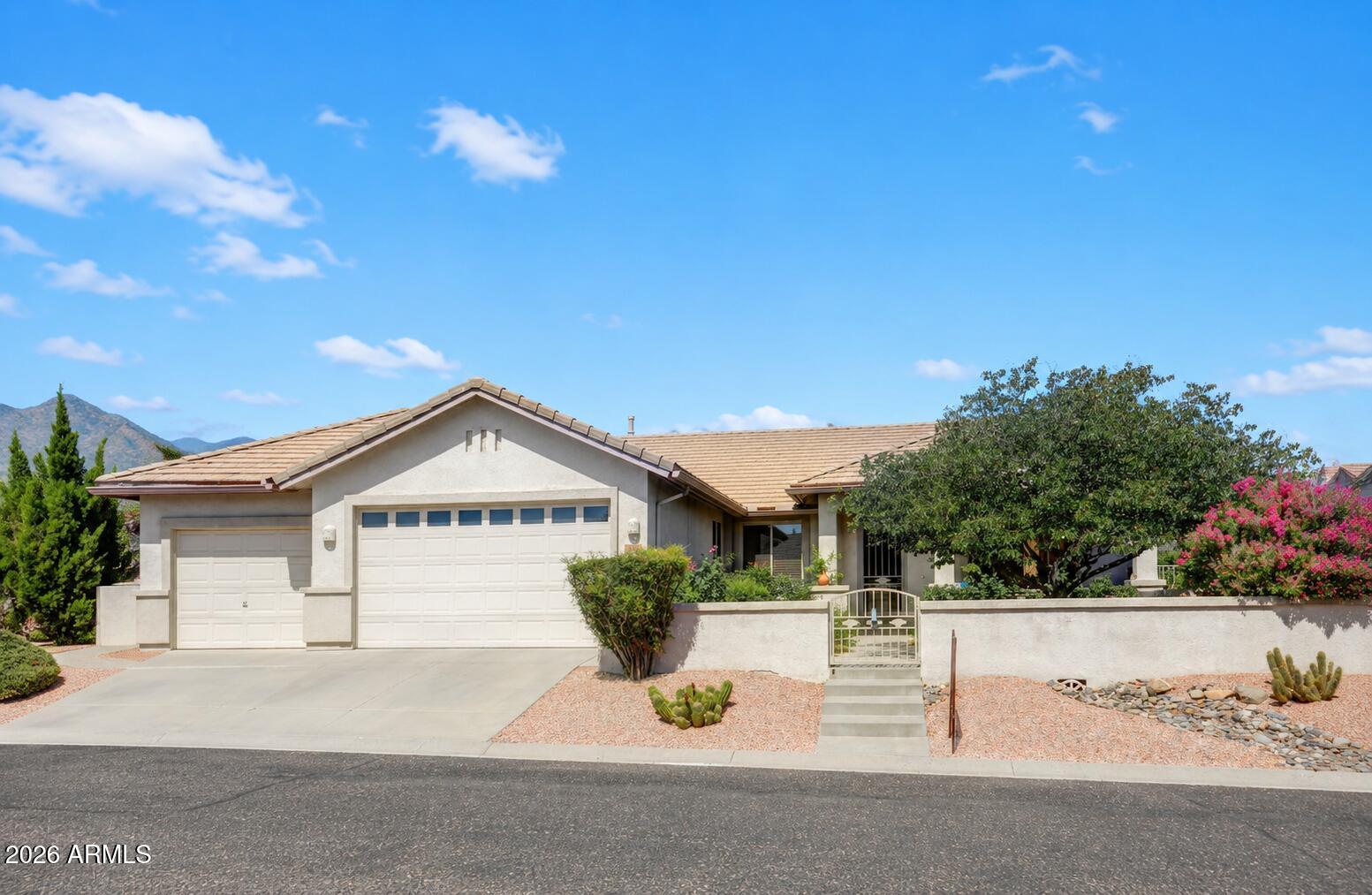 This is the home you have been waiting for- location, location, location! Meticulously maintained and truly move-in ready, this exceptional property reflects pride of ownership inside & out.  Thoughtful updates include the kitchen, bathrooms, flooring, windows, lighting, fans, and mini -split systems. Additional features include owned solar panels with battery backup, an electric vehicle hookup, gas fireplace, kitchen island, Nuvo water softener, reverse osmosis system, Murphy bed & dedicated office space. The professionally landscaped exterior offers an extended covered patio with beautiful mountain views & open land behind the home, while the garage features a finished floor & added cabinetry for convenient storage.  Enjoy resort-style living year-round with walking, hiking, biking paths a clubhouse with a variety of activities, a heated saltwater pool, spa, fully equipped fitness center, and a park. This beautifully updated home offers comfort, convenience, and an exceptional lifestyle.