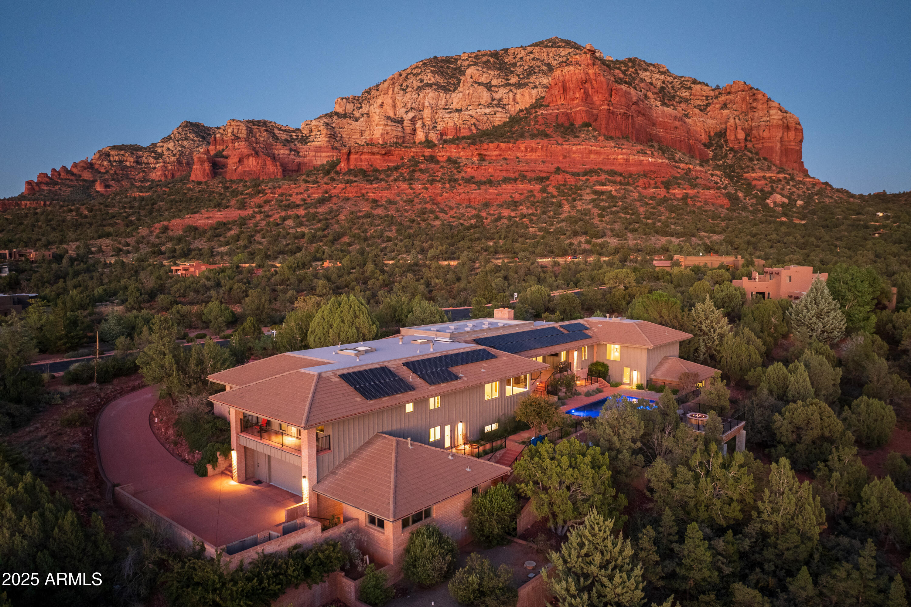 Enjoy breathtaking red rock views from this 8,377 sq. ft. fully remodeled luxury home, completed in fall 2024 and located in a premier gated subdivision in West Sedona. The property features resort-style living with a heated pool, hot tub, water feature, private guest casita (house) with a kitchenette, and a circular driveway leading to an enclosed front courtyard with a Feng Shui water feature. Inside, the home offers a well-appointed gourmet kitchen with new appliances, new temperature-controlled glass-enclosed wine wall, entertaining wet bar, and a cozy fireplace in the family room.  Enjoy movie nights in the home theater and stay active in the fitness gym with its own private bathroom. The primary suite includes a sitting room and a spacious walk-in closet. Truly exceptional! 30-Day Rentals.