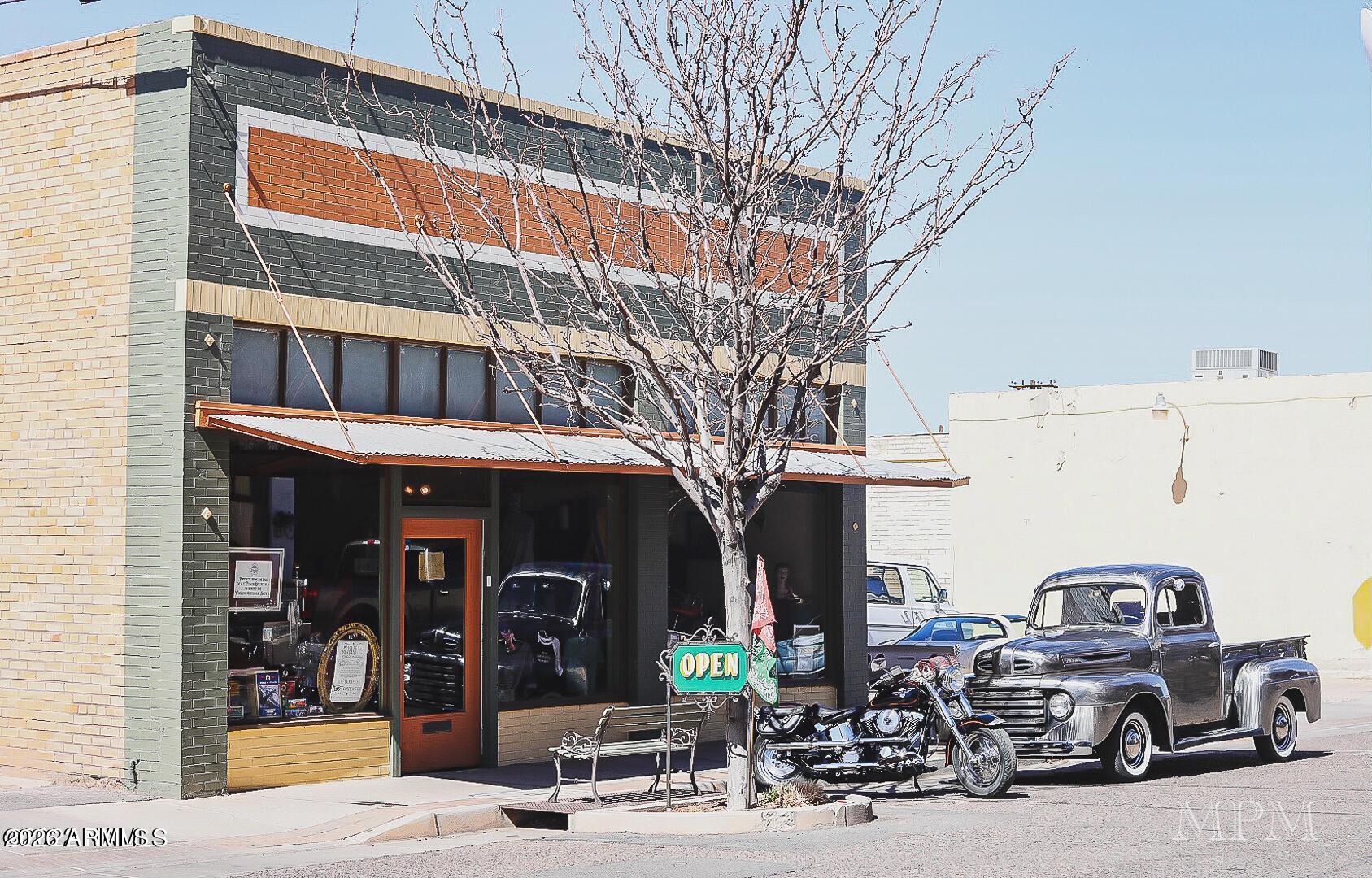 A unique opportunity in the heart of Winslow Arizona's burgeoning Route 66 District! This Historic Property sits between westbound Route 66 and eastbound Route 66, right next to the key attraction in town: The Standin' on the Corner Park. The building is located within the commercial/residential zoned Route 66 overlay, which means the 4200 square foot building could be used as both a business and a home or Airbnb. The building, which is on the historic registry, is one of the few downtown with its own parking lot. The store front is approximately 1000 square feet and features large showcase windows across the entire width of the building with raised platforms made from 100-year-old hardwood flooring. The store is brightened by the patterned tin ceilings.