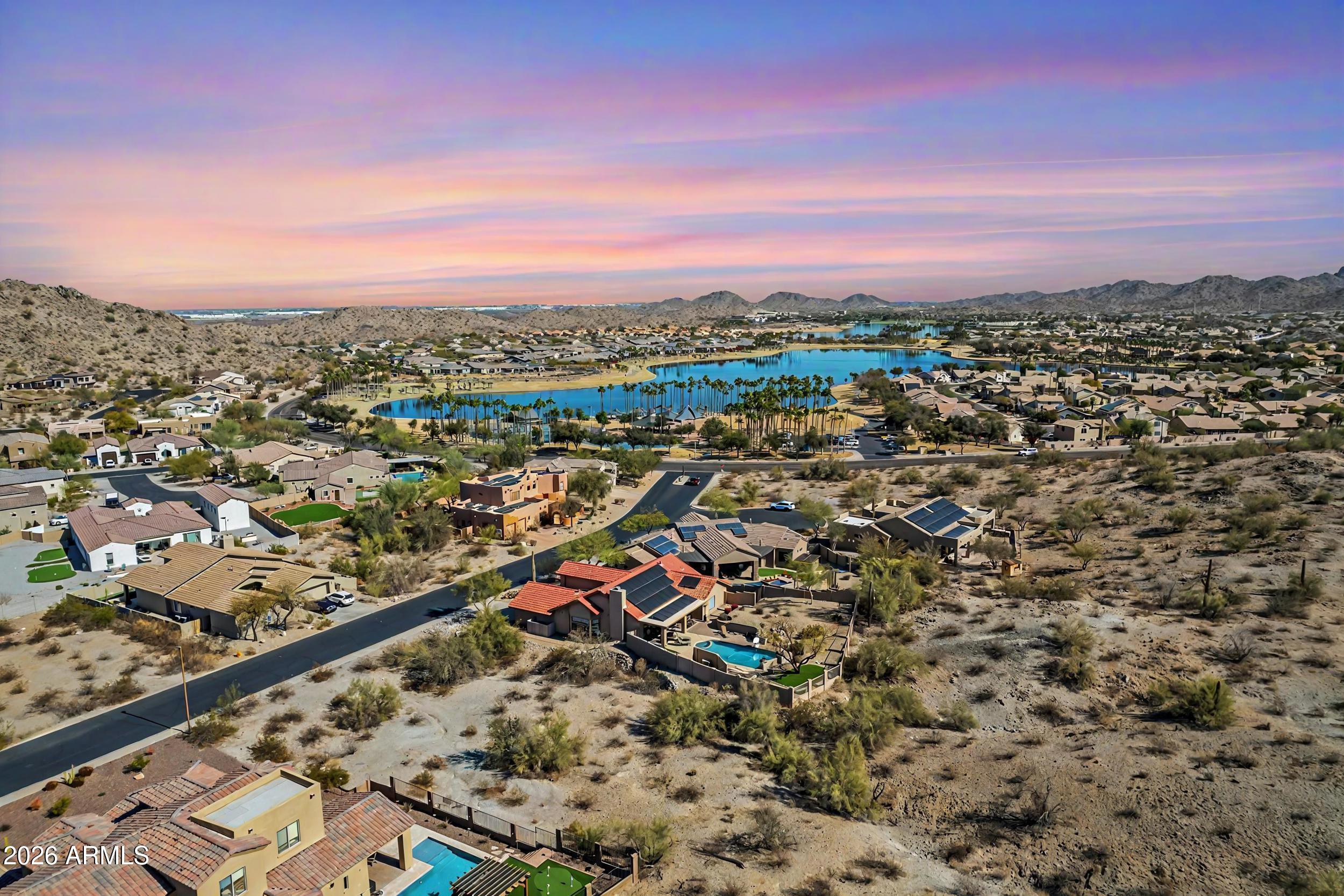 Custom Home Lot in Estrella Mountain Ranch, A Resort Style Master Planned Community. Large Lot with City Water, Sewer and Power at the Property. Lot is Surrounded by Spectacular Mountain Views and Is steps from South Lake and South Lake Park and its Amenities. Upscale Community Amenities Include 72 Acres of Stocked Lakes with Water Vessel Rentals, Shaded Parks, Award-Winning Golf Course, Restaurants, Waterpark, Splash Pads, Heated Pools, Club Houses, Fitness Centers, Sport Courts, Sport Fields, IB and STEM Schools, All Ages Clubs, Over 50 Miles of Biking/Running/Walking Paths and Hiking Trails. End Each Day with Unforgettable High Sonoran Desert Sunsets.