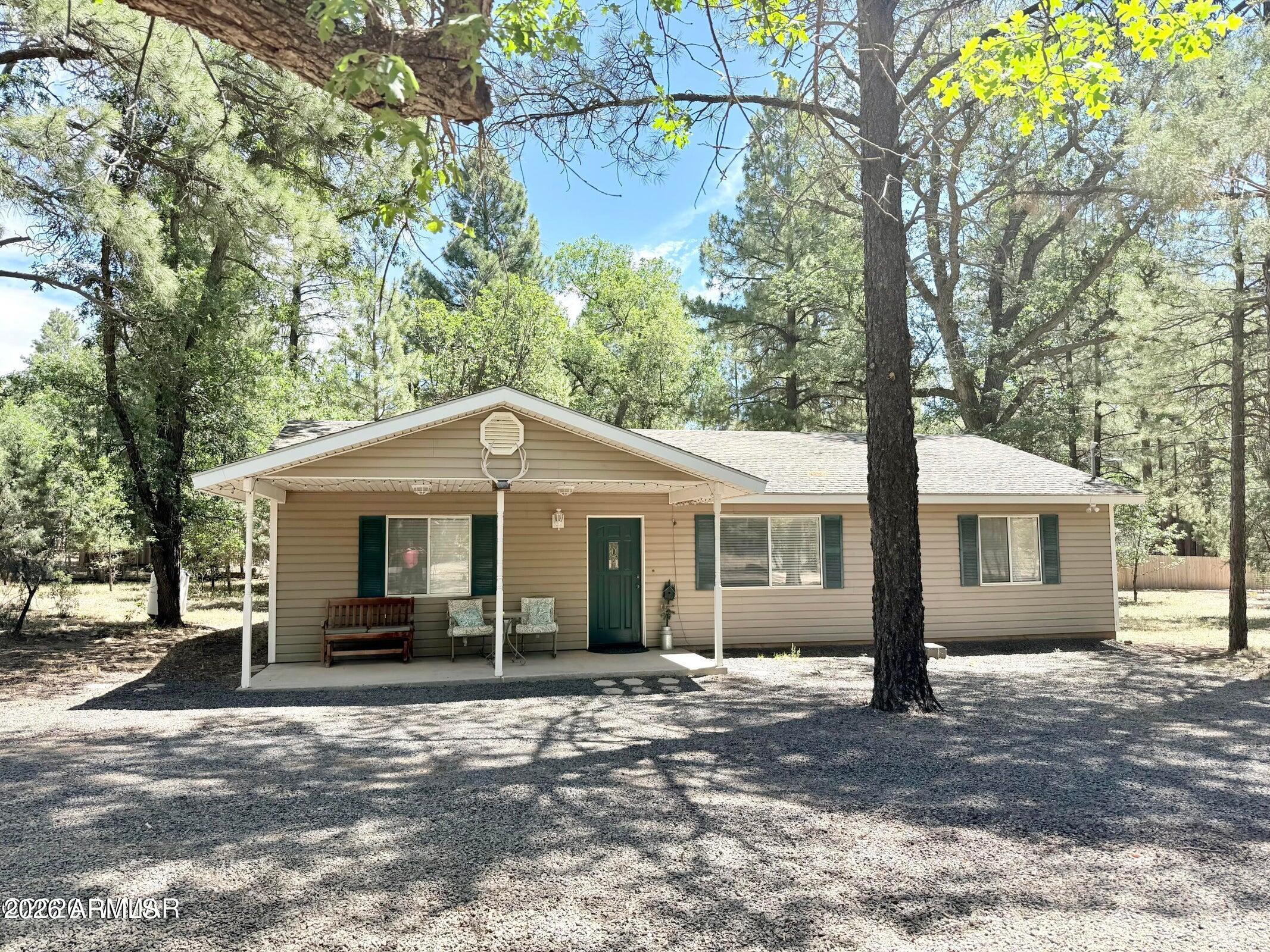 BEAUTIFUL CABIN SITUATED ON OVER AN ACRE OF LAND WITH TALL PINES AND PAVED ROAD ACCESS ALL THE WAY TO THE HOME. THIS HOME BOASTS THREE BEDROOMS, TWO FULL BATHS, LARGE GREAT ROOM WITH VAULTED CEILINGS AND SKYLIGHT, LARGE EAT IN KITCHEN WITH LOTS OF CABINETRY WITH 42'' UPPERS, ALL APPLIANCES CONVEY (WASHER, DRYER & FRIDGE), INSIDE LAUNDRY WITH STORAGE CLOSET, LOTS OF WINDOWS, LIGHT AND BRIGHT, CEILING FANS THROUGHOUT, NEW HVAC UNIT TO BE INSTALLED PRIOR TO CLOSING. OUTSIDE YOU WILL ENJOY THE TALL PINES, WALK OUT DECK IN THE BACK YARD AND COVERED PATIO IN THE FRONT. THIS IS A WONDERFUL HOME FOR FULL TIME USE OR A PERFECT RETREAT FOR THE WEEKENDS. LESS THAN 10 MINUTES TO SHOW LOW FOR SHOPPING, DINING AND ENTERTAINMENT.