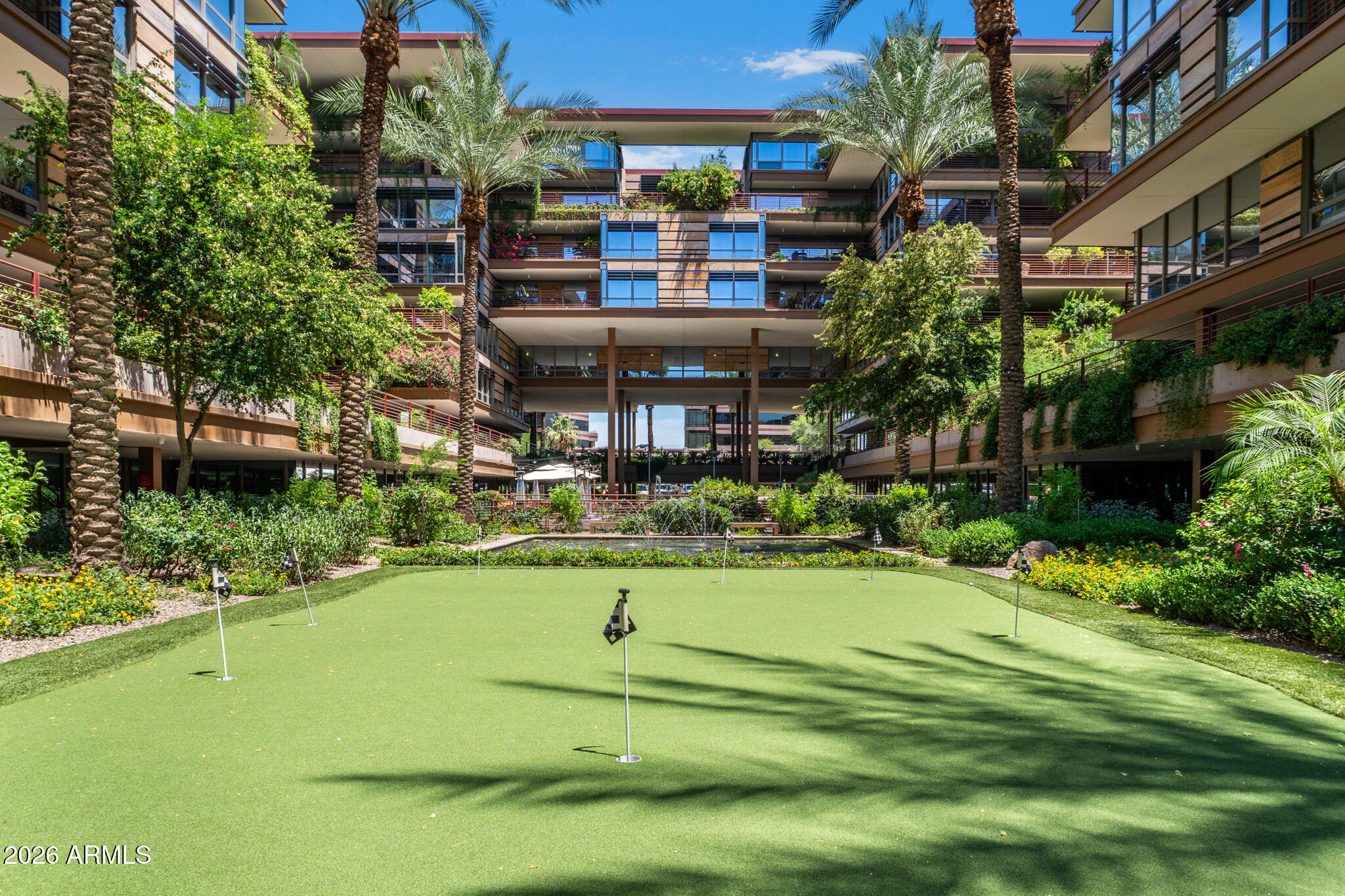Townhouse-style living at Optima Camelview, featuring one of the few backyards open to Camelback Mountain. Optima Camelview is Old Town Scottsdale's premier community thanks to its eye-catching architecture, perfect location, and resort-like amenities. Two outdoor pools with jacuzzis and one indoor lap pool. Indoor fitness center with weights, treadmills, steam rooms, lockers, and basketball, pickleball, and racketball courts. Reservable party room, meeting room, and yoga room. Concierge services and on-site management provide quality services. Putting green and waterfalls in the courtyard. Community EV charging in the garage. Many on-site businesses, including the neighborhood's favorite restaurant: Metropolis.