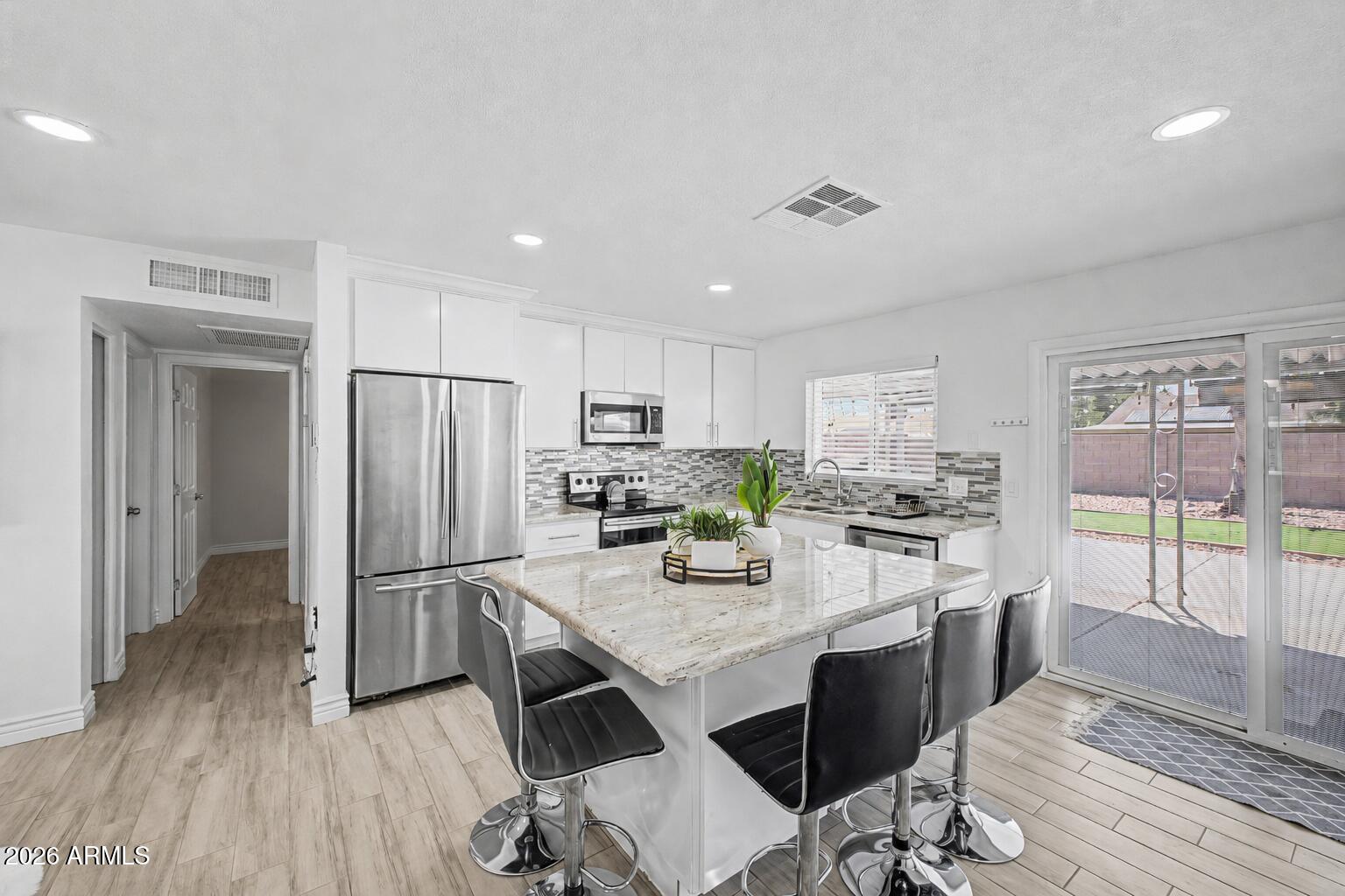 Welcome to this beautiful 3 bedroom, 2 bath home with 2 Primary Bedrooms offering 1,156 square feet of comfortable living space with NO HOA! Fresh interior paint and modern finishes throughout create a bright, inviting atmosphere from the moment you arrive. The heart of the home is the stylish kitchen featuring granite countertops, a large center island, stainless steel appliances, contemporary cabinetry, and a stunning tile backsplash. The open concept design flows seamlessly into the living and dining areas, making the space ideal for both everyday living and entertaining. Outside, you'll appreciate the low maintenance desert landscaping, attractive curb appeal, and the freedom that comes with no HOA restrictions. The spacious backyard is perfect for relaxing or hosting gatherings, complete with a gazebo for shaded outdoor enjoyment and a storage shed for added convenience and organization. Conveniently located near shopping, dining, parks and schools, this move-in ready home offers the perfect blend of comfort, style, and functionality. Whether you're a first-time homebuyer, downsizing, or looking for an investment opportunity, this home is one you won't want to miss.