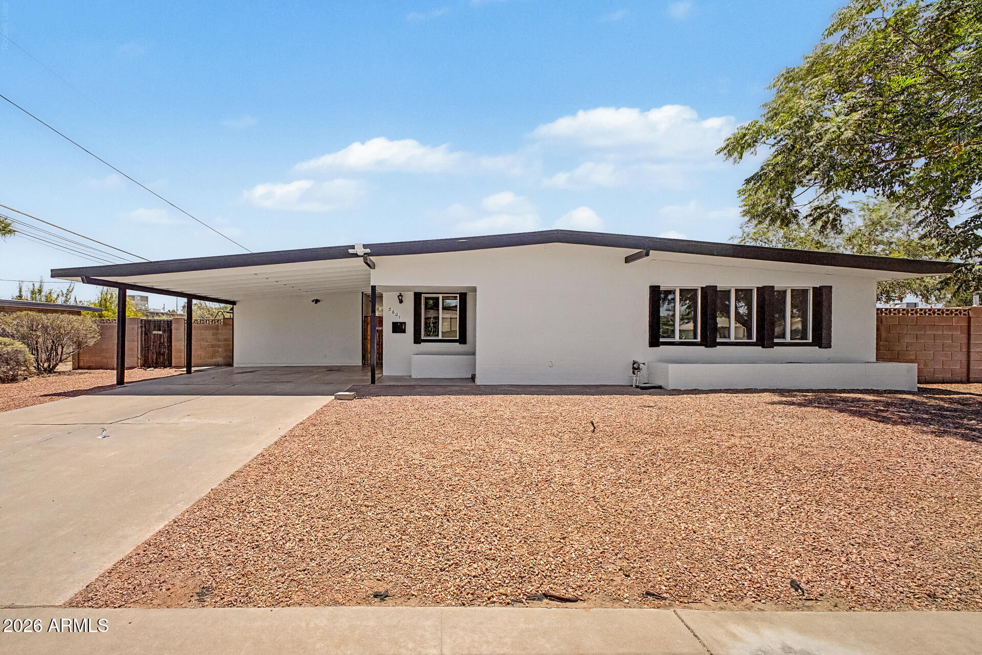 Mid-Century Modern Charmer in the heart of Phoenix! Ideally located near freeways, shopping, dining, parks, and everyday conveniences. This thoughtfully updated home features a 2025 kitchen remodel, new tile flooring, owned solar panels, and major system upgrades including HVAC and roof replaced in 2022. Enjoy the spacious corner lot with a covered paver patio, walkway, and backyard space complete with a shed and playground that convey!