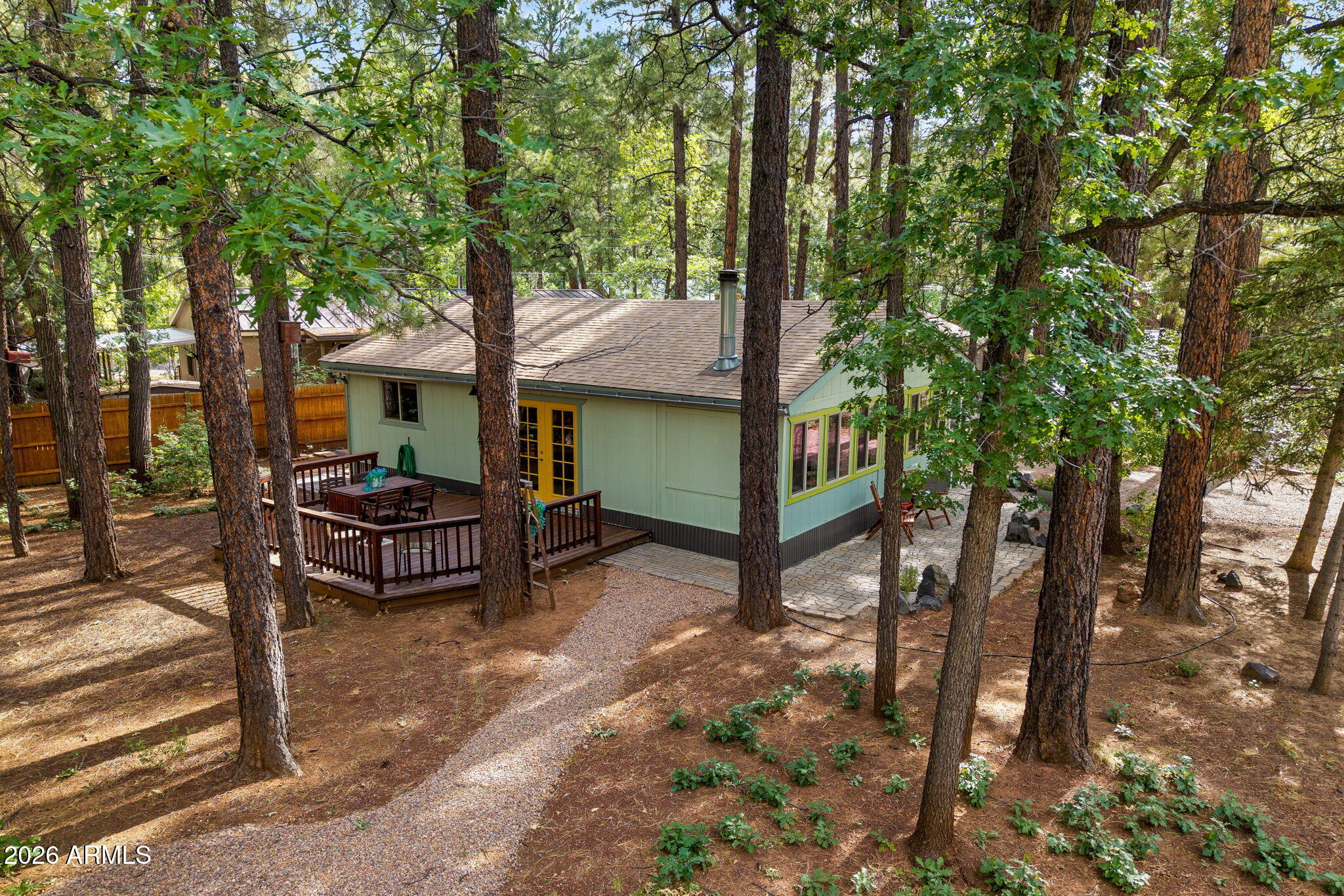 Surrounded by towering pines and fresh mountain air, this charming turn-key, fully furnished 2-bedroom, 1-bath cabin is the perfect retreat for relaxing getaways or a proven short-term rental opportunity. This cabin is ready to enjoy from day one. True pride of ownership is evident throughout this beautifully remodeled cabin, updated in 2023 and 2026 with a thoughtfully designed artisan-style interior featuring an open-concept layout filled with natural light, ash shaker cabinetry, a rich acacia wood island with built-in range, and stainless-steel appliances. Durable and easy-care wood-look luxury vinyl plank flooring and updated lighting throughout create a clean, modern cabin feel while maintaining its cozy charm. Spend crisp mountain evenings by the wood stove or step outside to over 750 sq ft of outdoor living space. The spacious 17x20 deck and multiple paver patios provide the perfect setting for morning coffee, entertaining, or relaxing under the stars.

Firewise-conscious improvements, including a newer roof, cleared landscaping, and paver patios, offer added peace of mind for both personal enjoyment and rental potential.

Whether you're seeking a serene retreat in the pines or a turnkey, income-producing getaway, this cabin delivers the best of mountain living.

FEATURES below and also attached in the document tab:

This Cabin's Artisan Remodel was started in 2022-23 and finished in 2026 and includes:

** Entire Kitchen remodel with cabin Ash shaker style cabinets, Tiled wall and counter-tops
** Added Acacia wood kitchen island
** New appliances; refrigerator, stove, dishwasher, dryer,
** New asphalt roof
** New efficient baseboard heaters
** 3 new paver patios (south, north and west sides)
** All new double paned vinyl windows
** Added additional new light fixtures
** Updated bathroom; new tiled and designer wood slated walls, ** new bathroom vanity
** New paint Inside and Out
** Added bedroom barn door
** All new aged looking no-worries- easy care vinyl plank flooring
** Added new utility sink
** Rejuvenated 16'x20' east/south Deck
** Upgraded wood stove tiled surround and paver pad for looks and safety
** New Wood window, door and floor trim throughout
** New beds, 2 additional fold out couch/beds - sleeps 6
** New updated and revived treasures style furnishings
** All new energy efficient cellular blinds
** New roof Gutters
** New skirting - all sides of house
** Additional rocked new RV parking and re-rocked existing driveways
** RV clean-out
** Turn key fully Furnished- Sale includes furnishings inside and out

Fire Safe Ready; permanent fire safe defensible space was created with fire retarding
asphalt shingled new roof.
The ignition resistance of the home was increased by treating into the 0'-30' Home
Ignition Zone with the addition of non burning paver patios on 3 sides of the home
( Product FLAME CHECK can be sprayed to the east side deck to retard ignition of wood
deck by fire brands). Two newly rocked driveways also increase the inability for fire
spread.

***

Discover the White Mountains of Arizona--where adventure, beauty, and fresh mountain air come together. Enjoy four stunning seasons, 40 lakes, and 600+ miles of rivers and streams, perfect for fishing, kayaking, and exploring.

Hit the trails on one of the largest trail systems in the Southwest, or spend winter days at Sunrise Ski Resort, just 40 minutes away with three mountains of skiing, snowboarding, and sledding.

Love shopping or culture; wander through antique shops, summer arts & craft fairs, and lively music festivals. Golfers can tee off at seven scenic courses, including three public gems.

It's no wonder Pinetop-Lakeside was voted the "Best Cabin Region in the U.S."

The White Mountains--Arizona's best-kept secret. Come explore and embrace the MAGIC!