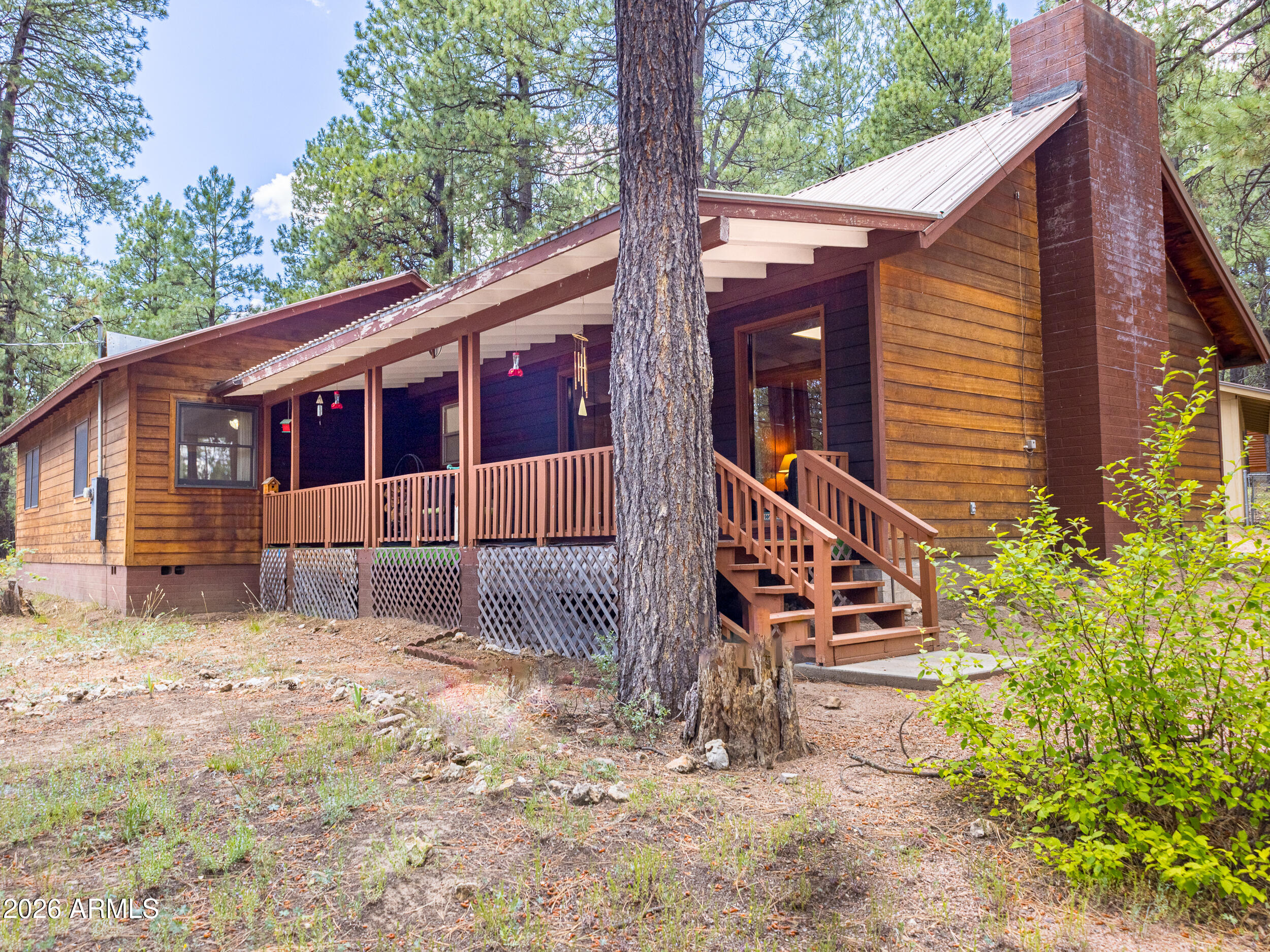 Escape to the cool pines with this charming rustic cabin nestled on a private 1-acre lot in desirable Forest Lakes. This inviting 3-bed, 2-bath home offers the perfect blend of cozy cabin character and comfortable living. Warm wood siding, rustic finishes, and an inviting atmosphere make this mountain retreat feel like home from the moment you arrive.

The spacious living room provides plenty of room to gather with family and friends, while the front porch is the perfect place to relax, enjoy the fresh mountain air, and take in the peaceful surroundings. Situated on a quiet street, the property offers exceptional privacy. Outside, you'll find an oversized detached single-car garage with extra space for storage or a workshop, along with a convenient garden shed for tools and outdoor equipment. If you're looking for a residence, weekend getaway, or vacation rental opportunity, this Forest Lakes cabin is ready! This nice at this price point doesn't happen often, so you'll need to move fast on this one.