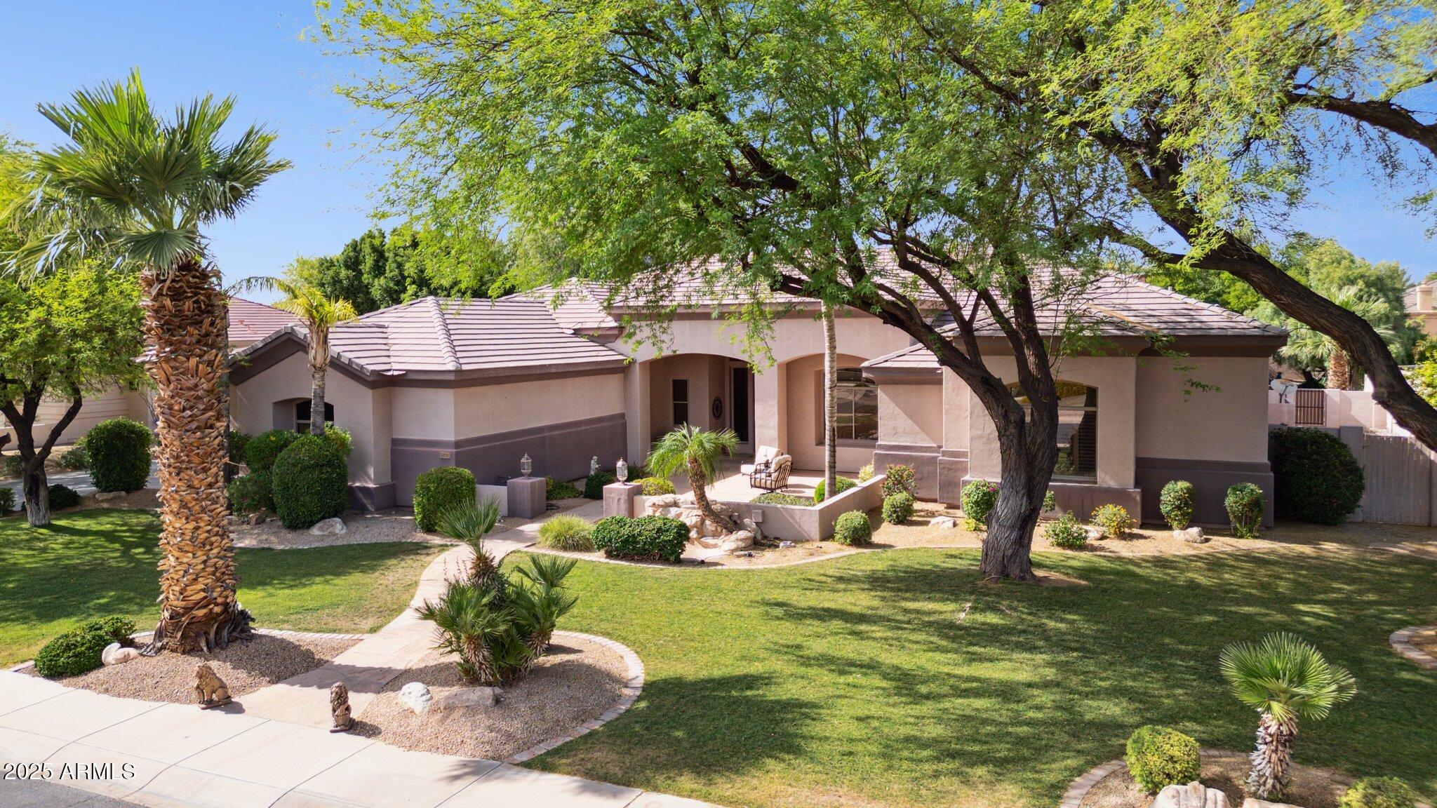 In an area of lush horse farms, this 4BR/4ba + separate office, 4005 sf home is in a classy, privately-gated subdivision of only 31 homes!  Three large wood-structure gazebos (35x25, 13x13, and 12x20) for perfect outdoor enjoyment! Built-in stacked-stone grill, table-top fire, outside TV mounts, fireplace, 3 misters, putting green, koi pond, waterfalls, heated pool and spa, gas fire table, large open grass area, party lights, room for pool table. RV gate, mature landscaping and lush trees, plus community park!  New interior white paint !  Near Banner Thunderbird Hospital, ASU West Campus, great schools, parks with tennis and pickleball!  Four BRS (3 en-suite), sep office, quiet interior lot, 3-car garage with 23' of custom built-in cabinets. Easy access to stadium and Westgate Ent District