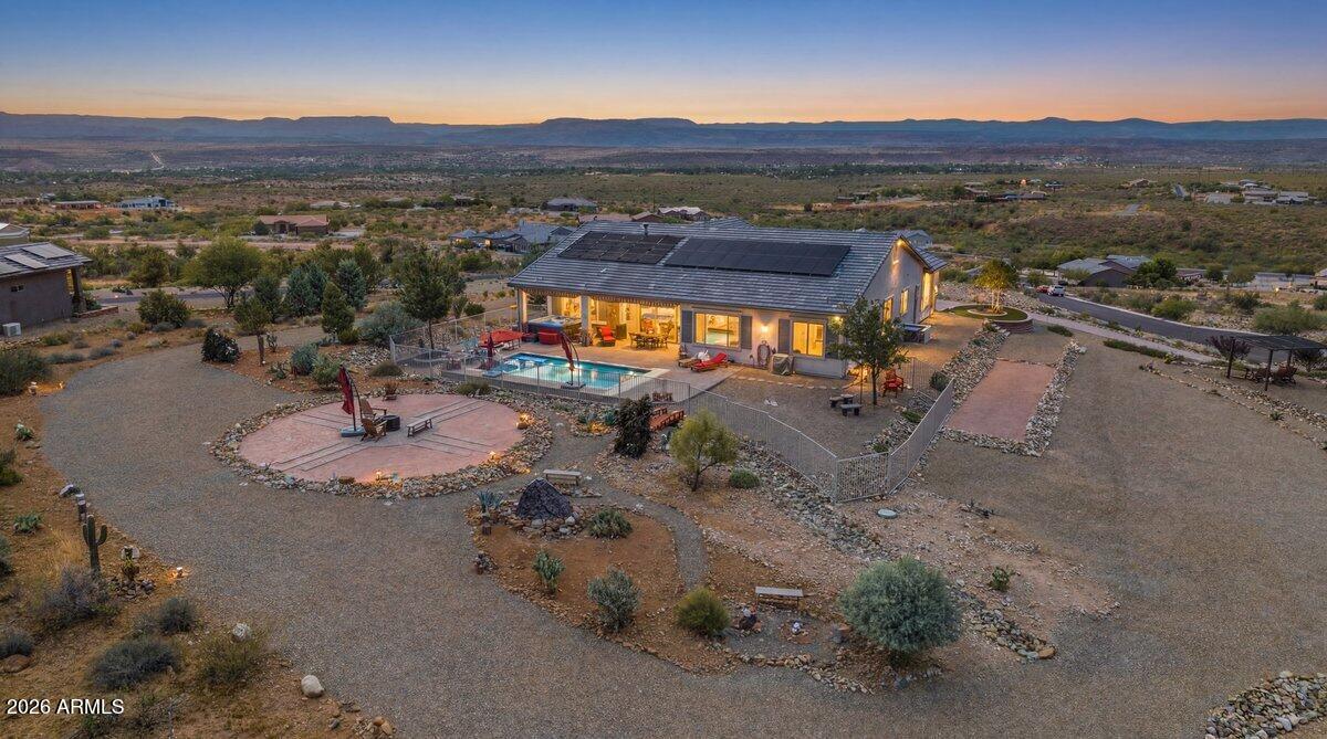 Welcome to a place where every sunrise inspires, every sunset captivates, and every moment feels like a private retreat. Perched atop one of the most desirable hilltops in the prestigious Quail Canyon community, this extraordinary custom estate offers a lifestyle few properties can match. Situated on a private 2.55-acre gated cul-de-sac lot, this rare sanctuary captures breathtaking 360-degree panoramic views of the Verde Valley, Mingus Mountain, and Sedona's iconic red rocks, creating a setting that is simply unforgettable.
Built in 2019 and thoughtfully enhanced with over $270,000 in upgrades, this stunning 3-bedroom, 2.5-bath residence offers over 2,300 square feet of luxurious living space designed to embrace the beauty of its surroundings. From the moment you step inside, you'll be captivated by the abundance of natural light, soaring views, and seamless open-concept design that allows nature to become part of everyday living. Expansive windows frame spectacular scenery from every room, creating an atmosphere that is both elegant and inviting.
At the heart of the home, the gourmet kitchen flows effortlessly into the spacious living and dining areas, making it ideal for entertaining family and friends. The beautiful fireplace creates the perfect setting for cozy evenings, while the ever-changing landscape outside provides a stunning backdrop of colorful sunsets, twinkling valley lights, and endless mountain vistas.
Every room has been thoughtfully designed to maximize comfort, privacy, and breathtaking views. Whether enjoying a quiet morning coffee while watching the sunrise over the valley or hosting unforgettable gatherings, this home offers a lifestyle that feels both luxurious and effortless.
Step outside and discover your own private resort. Relax beside the sparkling heated salt water pool, unwind in the spa beneath a blanket of stars, or enjoy a glass of wine while taking in some of the most spectacular sunsets Northern Arizona has to offer. The peaceful surroundings and unmatched privacy create a sense of tranquility that is rarely found.
Energy-efficient solar panels provide modern sustainability, while the meticulously maintained grounds offer the perfect balance of luxury and low-maintenance living. Every detail has been carefully considered to create a home that is as functional as it is beautiful.
Rarely does a property combine privacy, acreage, newer construction, luxury amenities, and truly jaw-dropping views in such a remarkable setting. This is more than a home--it's a destination, a sanctuary, and a place where memories are made for generations to come.
One of Quail Canyon's finest offerings, this extraordinary hilltop estate is a rare gem that must be experienced to be fully appreciated.