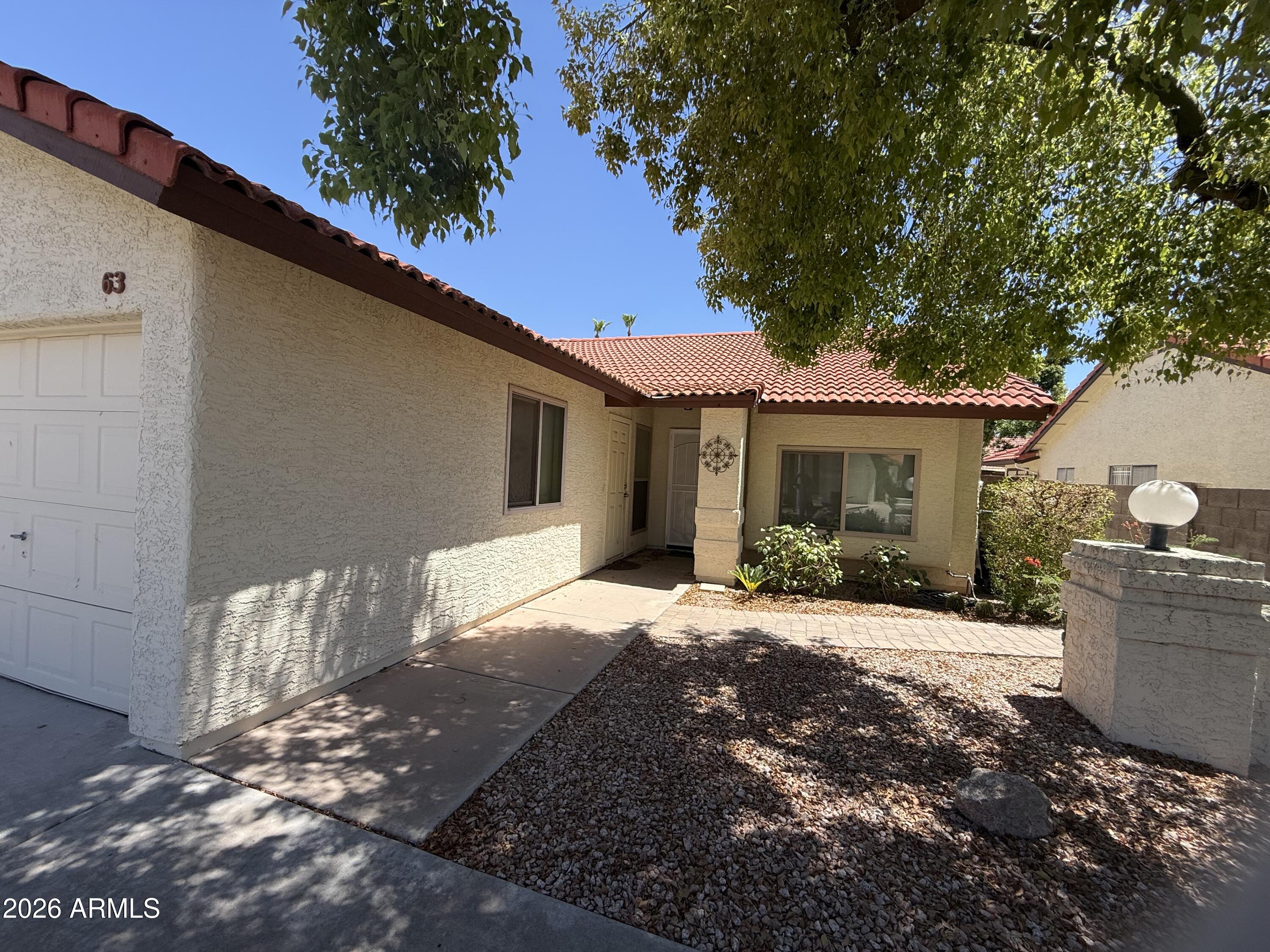 You'll love this adorable N/S sitting townhouse with 2 beds/2 baths, open great room/kitchen and screened in covered patio. The home is designed for easy living with no carpet and artificial grass in backyard. Updated with dual-pane low-e windows throughout, ceiling fans, granite counters in kitchen and bathrooms, and vaulted ceilings. The great room opens right into kitchen with breakfast counter and bay window looking towards charming backyard.  Enjoy the rec center, pool, quiet 55+ community.