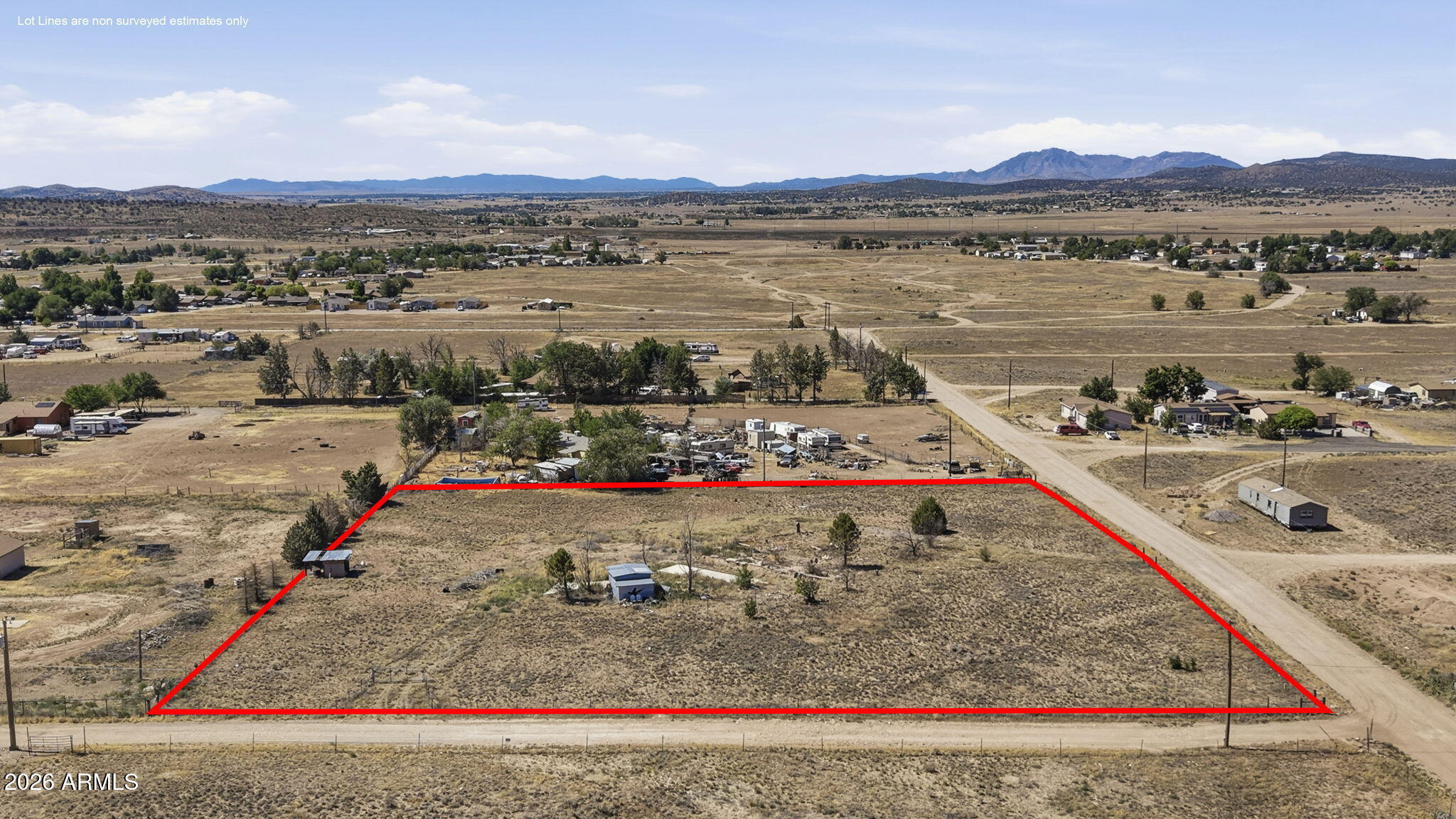Ready for a fresh start, this 2.36-acre property offers a level building area, mature trees, privacy, and views. The previous home has been completely removed, while valuable infrastructure remains to help save time and money when building or placing a new manufactured home. Improvements include a two-bedroom septic system, electric service, private water-company availability, propane availability, a gated and fully fenced lot, and an existing dirt driveway. Additional improvements include a 12-by-12-foot metal workshop on a concrete foundation, an attached 6-by-10-foot garden-supply and tool shed with a separate entrance and wood floor, plus a small three-sided storage shed suitable for an ATV or riding mower. With zoning that allows both site-built and manufactured homes, there is plenty of room for animals, RV parking, equipment, gardens, or additional outbuildings. Located on a dirt road with convenient access to a gas station, Family Dollar, and a local hardware store.