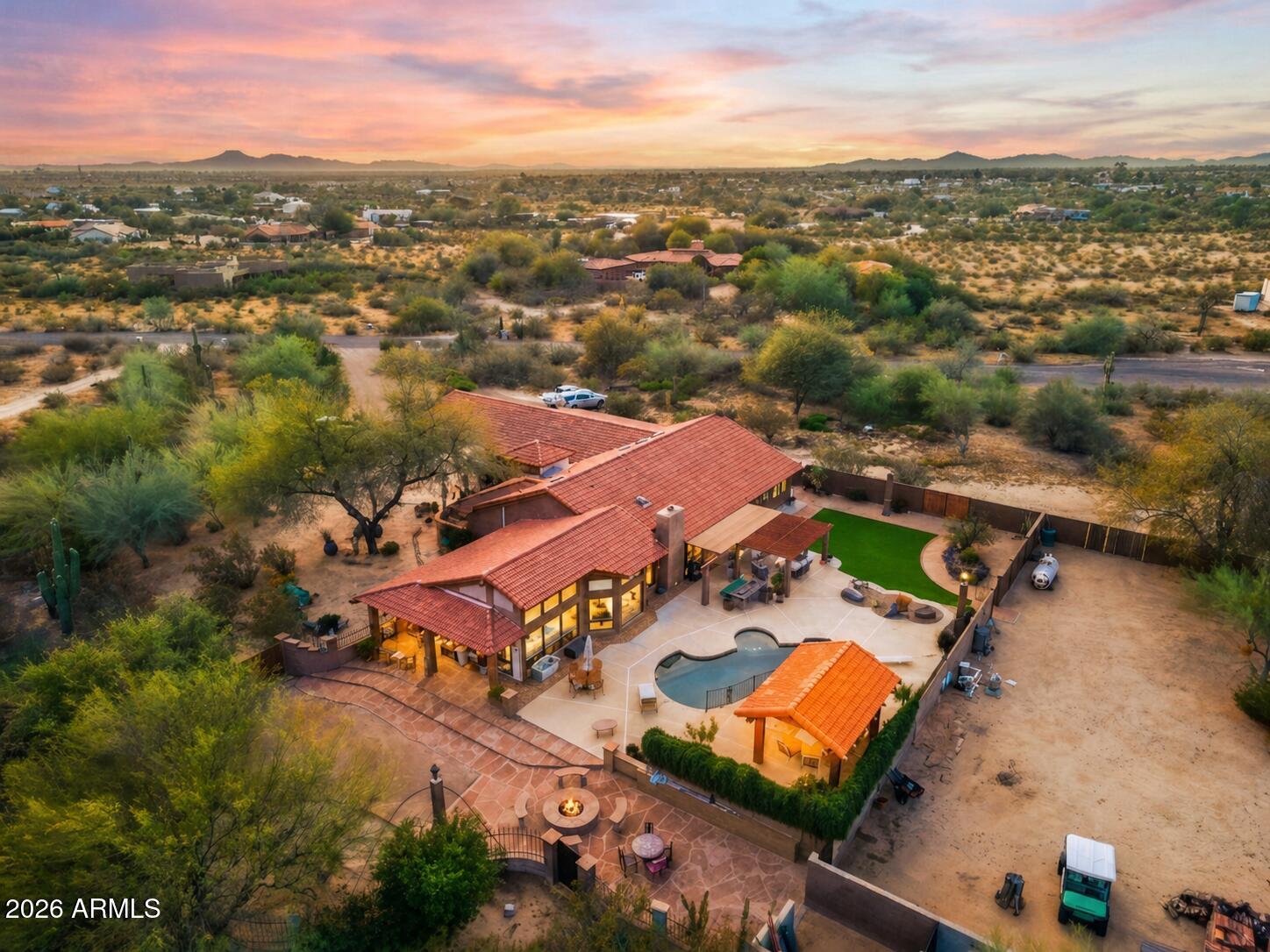 Experience luxury desert living with space, privacy, and breathtaking mountain views on 3.7 acres of pristine land. This stunning 4-bedroom split floor plan estate is designed for both comfort and functionality, offering expansive living spaces and exceptional natural light through beautiful windows and skylights. The spacious primary suite is a true retreat, featuring a bonus flex room perfect for a dream walk-in closet, private office, fitness studio, or relaxation space. The home includes three full bathrooms with high-end countertops and premium finishes, creating a spa-like feel throughout. A large laundry room with abundant storage adds everyday convenience. Step outside into your private resort-style backyard designed for entertaining and relaxation. Enjoy a diving pool, covered patios, and a raised gazebo overlooking the pool, along with a cozy fire pit and covered seating areas perfect for Arizona evenings. The property also features a second fully fenced yard ideal for equipment, storage, or workshop space, complete with pass-through RV gates for easy access.

Wrap-around covered patio seating allows you to enjoy the outdoors at any time of day--whether taking in spectacular sunrises, vibrant desert sunsets, or the peaceful mountain views surrounding the property.

This rare estate offers the perfect blend of luxury, land, privacy, and panoramic desert scenery, making it an exceptional opportunity for those seeking elevated Arizona living.