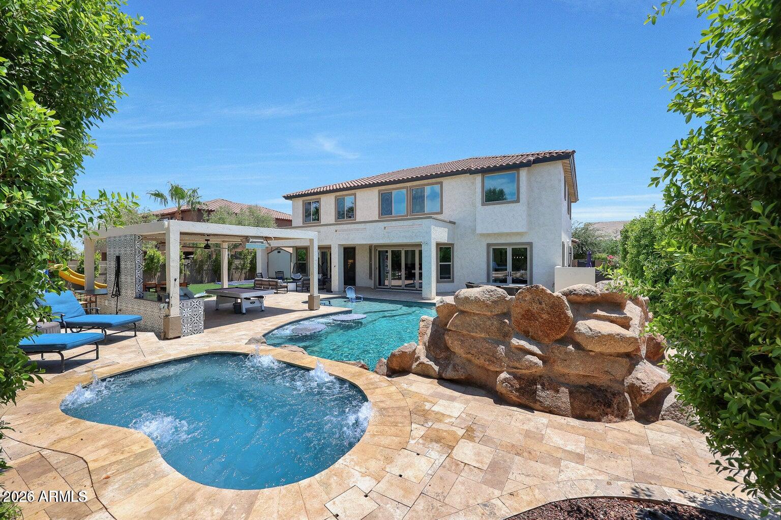 Stunning entertainer's dream home featuring a full private in-law suite and resort-style backyard! Step through the elegant iron front door into a spacious layout designed for comfort and entertaining. The chef's gourmet kitchen is truly one of a kind, featuring a 60'' professional gas range with double ovens, dual dishwashers (24'' + 18''), generous prep space, and high-end finishes.
This thoughtfully designed home includes two laundry rooms (upstairs and downstairs) for convenience and a private attached in-law suite on the first floor with its own entrance, patio, kitchen, and living space, perfect for guests, multigenerational living, or extended stays. The upstairs features a luxurious primary suite, additional bedrooms, and a spacious open loft area ideal for a media room, office, or play space.Step outside to your resort-style backyard built for entertaining, complete with:
" Built-in BBQ outdoor kitchen
" Two mini refrigerators & ice maker
" Bar seating area
" Sparkling pool with grotto & jets
" In-ground trampoline
" Hot tub/spa
Recent upgrades include AC system replaced in 2022. This rare and unique property offers luxury, flexibility, and incredible entertaining spaces both inside and out.