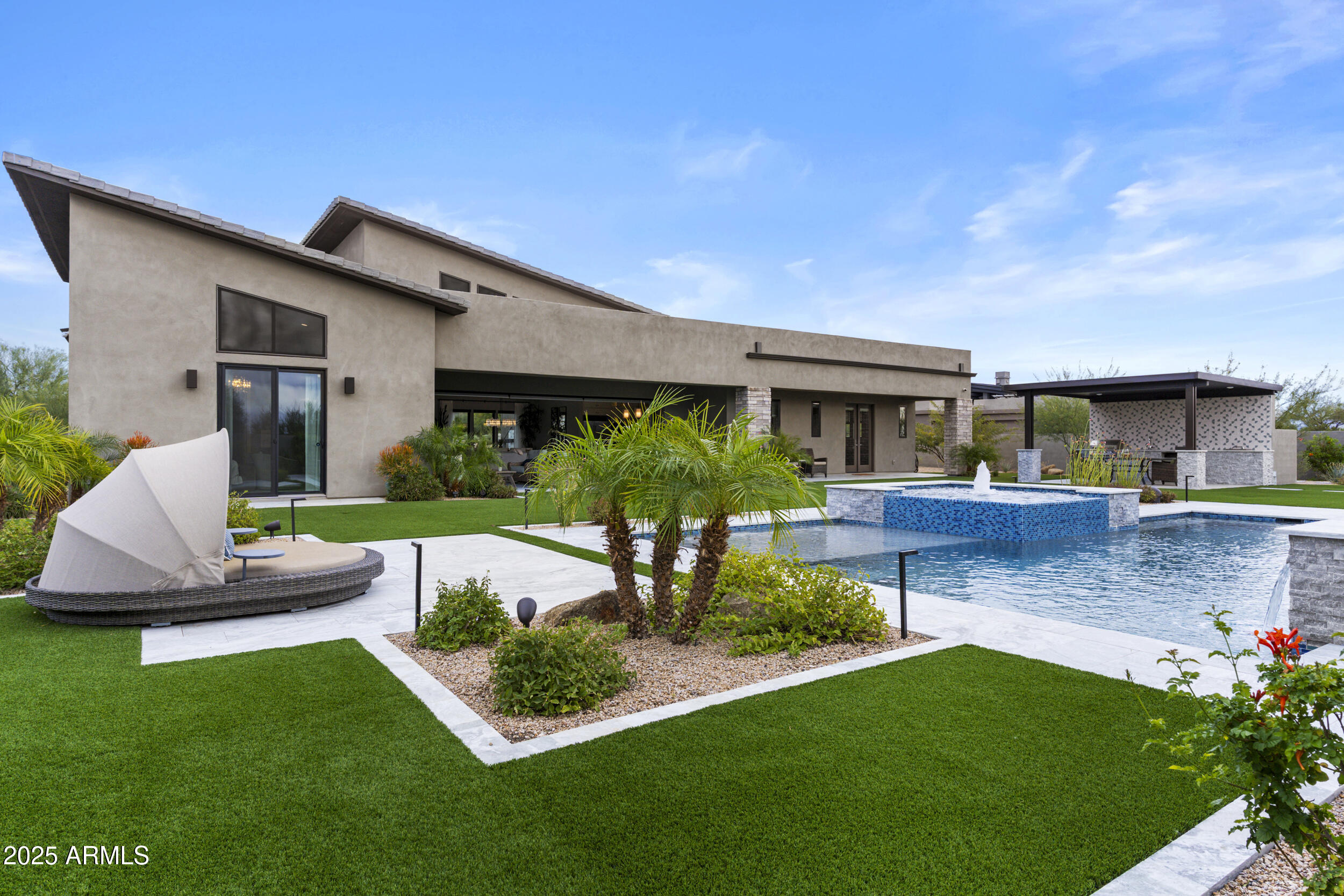 Stunning 2022-built mid-century modern home on a ¾-acre lot with sweeping views of The Boulders and Black Mountain. Designed for abundant natural light, this 3-bedroom, 3.5-bath residence features an expansive great room plus den, soaring ceilings, clean architectural lines, and an open floor plan. 3-car garage. A serene enclosed front courtyard showcases a dramatic water and fire feature. The resort-style backyard offers sunset views, a custom pool and spa, shaded gazebo, built-in BBQ, fire feature, citrus trees, artificial turf, and a meandering serenity garden designed for quiet reflection. Quiet neighborhood near golf, lakes, rivers, and the Tonto National Forest. Furniture is negotiable.