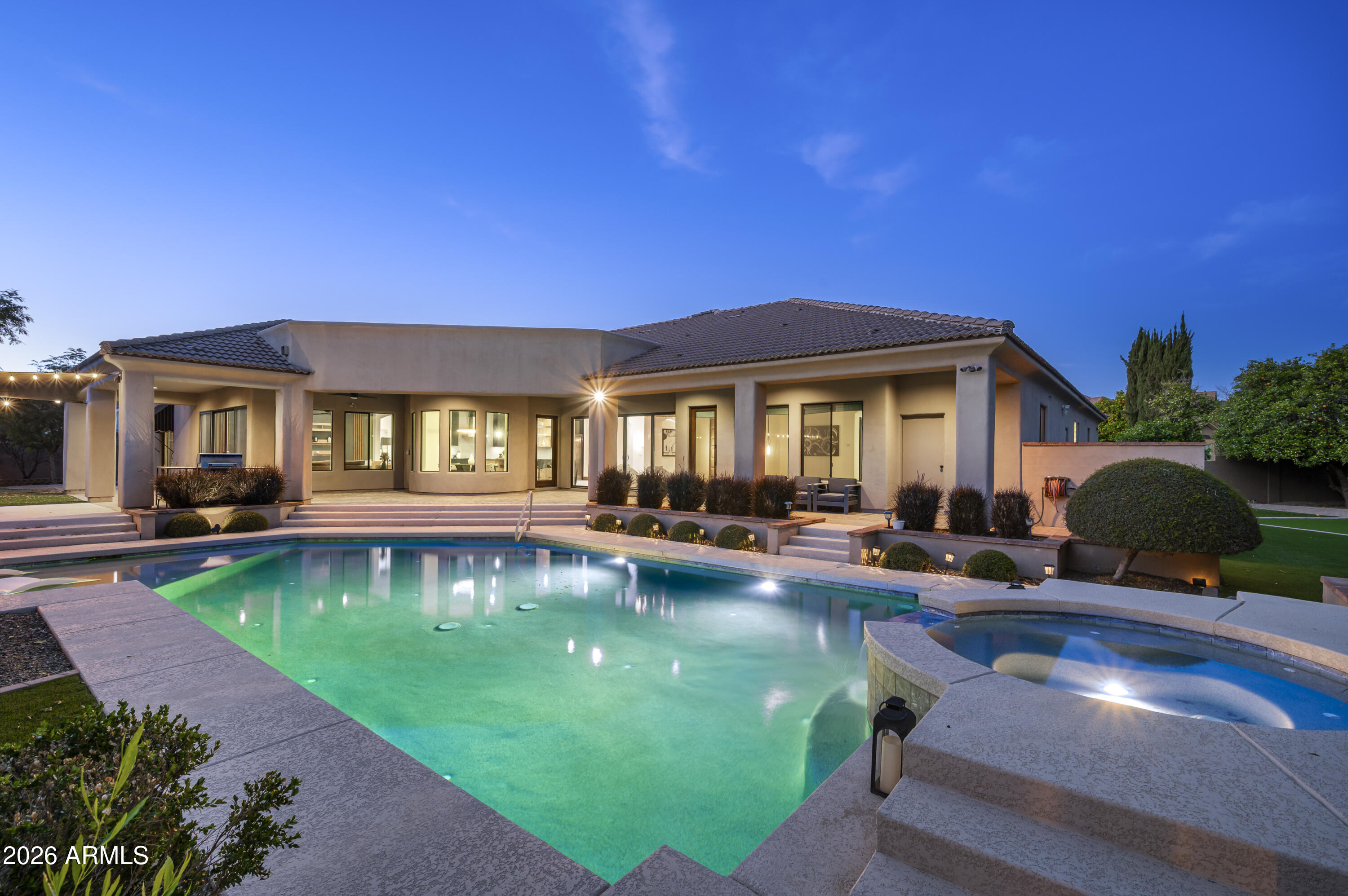 Located within the coveted gated community of Vista Estancia, this beautifully renovated contemporary estate offers the perfect blend of luxury living and resort style outdoor amenities. The home features five bedrooms, four and a half bathrooms, a detached casita, and a spacious four car garage. A gated courtyard entry welcomes you with a stately stone fountain before leading into a sophisticated interior highlighted by Restoration Hardware lighting, a dramatic water vapor fireplace, and expansive living spaces designed for both relaxation and entertaining.

The thoughtfully reimagined open concept floor plan centers around a stunning custom kitchen featuring an Aga Mercury gas range, a 66-inch built in refrigerator, and an oversized Black Pearl leathered granite island that anchors the space. Adjacent living areas include a large family room with a custom media wall, a stylish sitting room, and incredible entertainment spaces including a state of the art nine seat movie theater and a dedicated arcade game room.

The luxurious primary suite offers a private sitting area and a spa inspired bathroom complete with a freestanding soaking tub. Expansive sixteen-foot sliding glass doors create seamless indoor and outdoor living and open to an exceptional backyard retreat. Designed for entertaining and recreation, the resort style grounds include a pool with spa and baja step, five hole putting green, bocce ball court, built in barbecue, lush orchard landscaping, and a custom fully enclosed dog run. The detached casita with a full bathroom provides ideal accommodations for guests, a private office, or a separate workspace.