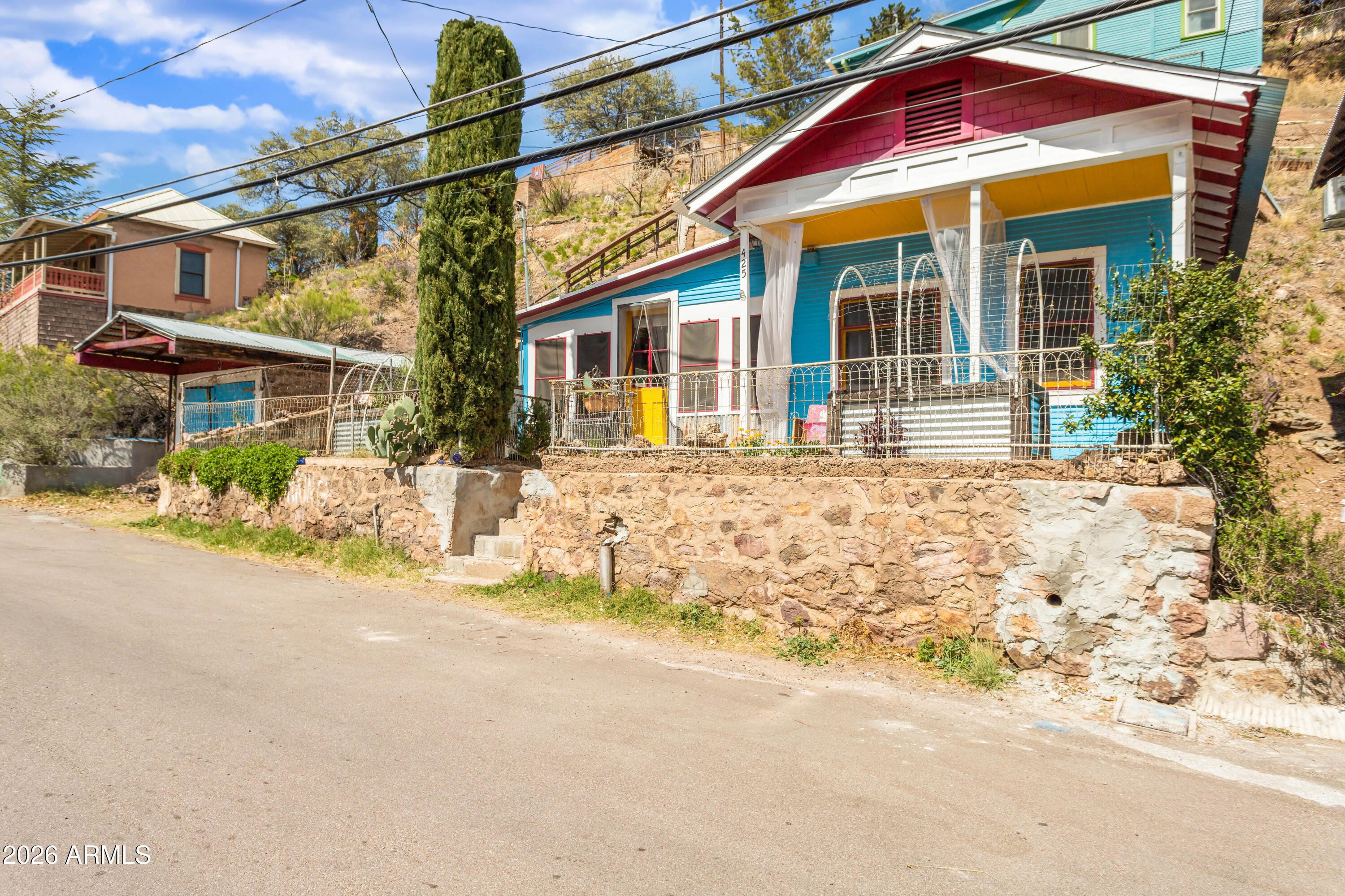 This colorful Bisbee miners cabin is close to hiking trails, parks, shops and restaurants in historic Downtown Old Bisbee. Built in 1914, this 2-bedroom, 1-bath home retains much of its original charm, featuring a clawfoot tub and 9ft beadboard ceilings. The garden and patio space are elevated just a few steps up from the street level, providing privacy. The garage can be used as a garage or finished into an office, home gym or guest quarters. The walls in all rooms, except the living room, have been reframed and insulated (2020). The floors in all rooms, except the living room, have been leveled (2020). Metal roof is less than 10 years old. New gas water heater (2025).