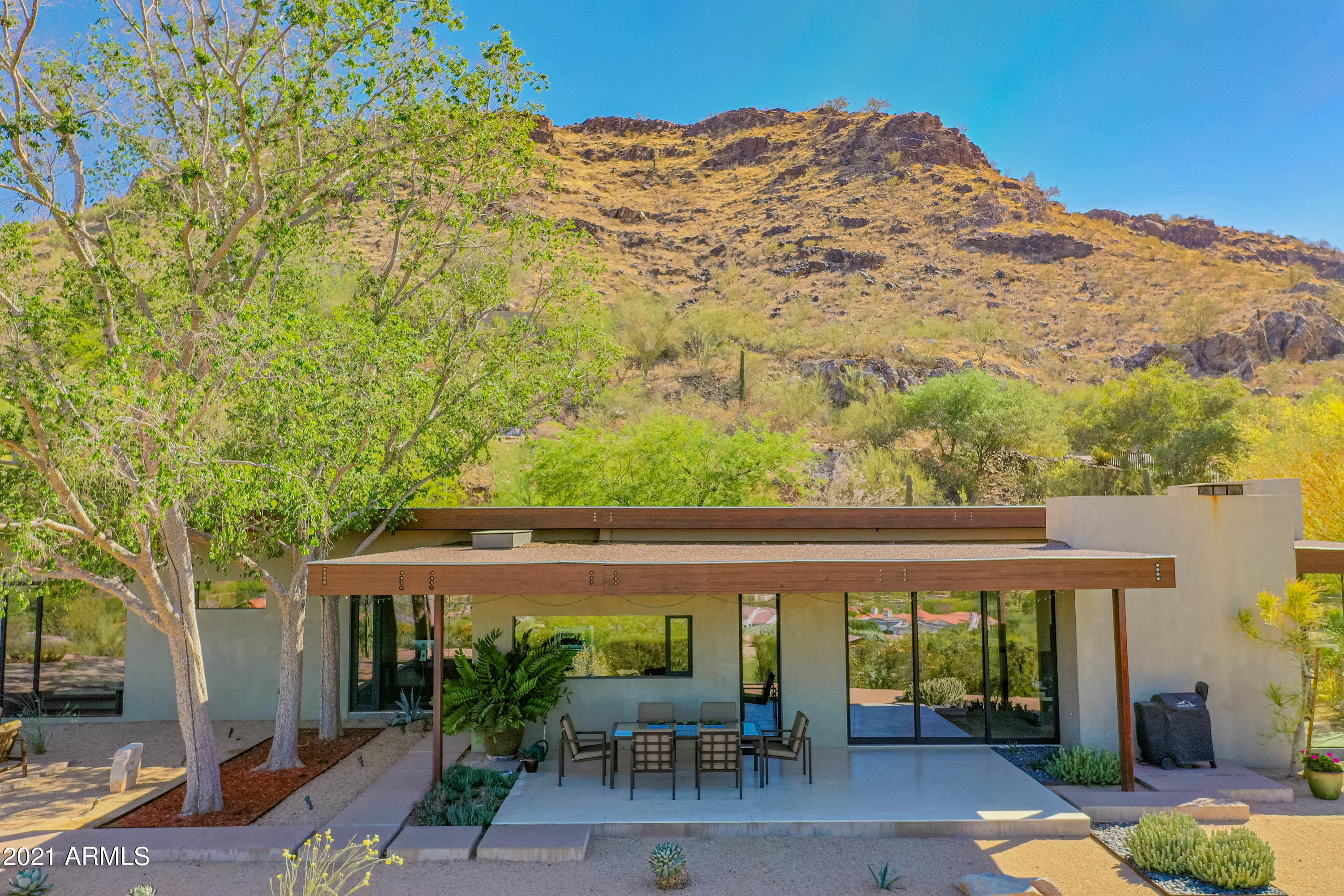 Photos do not do justice to the timeless design and thoughtful floor plan that make this modern hillside home the perfect retreat for dramatic views, breathtaking scenery, and ultimate privacy.  Nestled on the Northeast slope of Mummy Mountain  w/panoramic views of the McDowell Mountains, Four Peaks, Pinnacle Peak and all the way west to the Bradshaws, the vista will be ever changing.  Designed with floor to ceiling windows and natural light infusing each room, every space has been planned to take advantage of a special view. Clean lines and finishes complete this 3 bedroom 3.5 bath home. The architect has shown it is possible to add up to 1,600 sq ft to the existing home on ground level due to the flat lot and siting of the home. Addtl. photos coming.