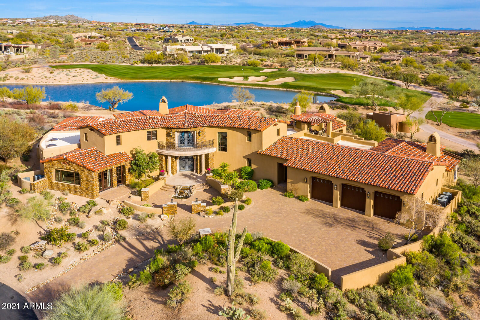 Rare tranquil location within Desert Mountain Club in North Scottsdale with home sitting across a lake viewing the entire hole & greens of 4th hole & down fairway of 5th hole the Renegade Golf Course. Exquisite golf course/lakeside living just inside DM's main gate. Gorgeous Santa Barbara-style Villa with stunning McDowell and Pinnacle Peak views. Expansive patios * best DM pool * upper viewing Gazebo that provides panoramic sunrise to sunset views *exquisite triple edged granite counters  throughout* finest selections of tile * mosaics * 6 hand carved Cantera fireplaces (4 interior, two exterior) * travertine floors throughout* luxury master suite w/ exercise room or cabana * home theater * wine room * guest house * European craftsman-quality ironwork throughout. Read on about the Club: Desert Mountain Club is a private guard-gated community on 8200 acres hosting 6 Jack Nicklaus Golf Courses plus a new Par 54 course, 9 Tennis courts, 6 Pickle Ball courts, 4 Boccie Ball, World Class Spa & Fitness Facility and 18 miles of private hiking/biking trails on 3000 acres backing up to Tonto National Forest. And, lets not forget the dining!! 10 different eateries from casual to formal and everything in-between. Truly something for everyone on the "Mountain"