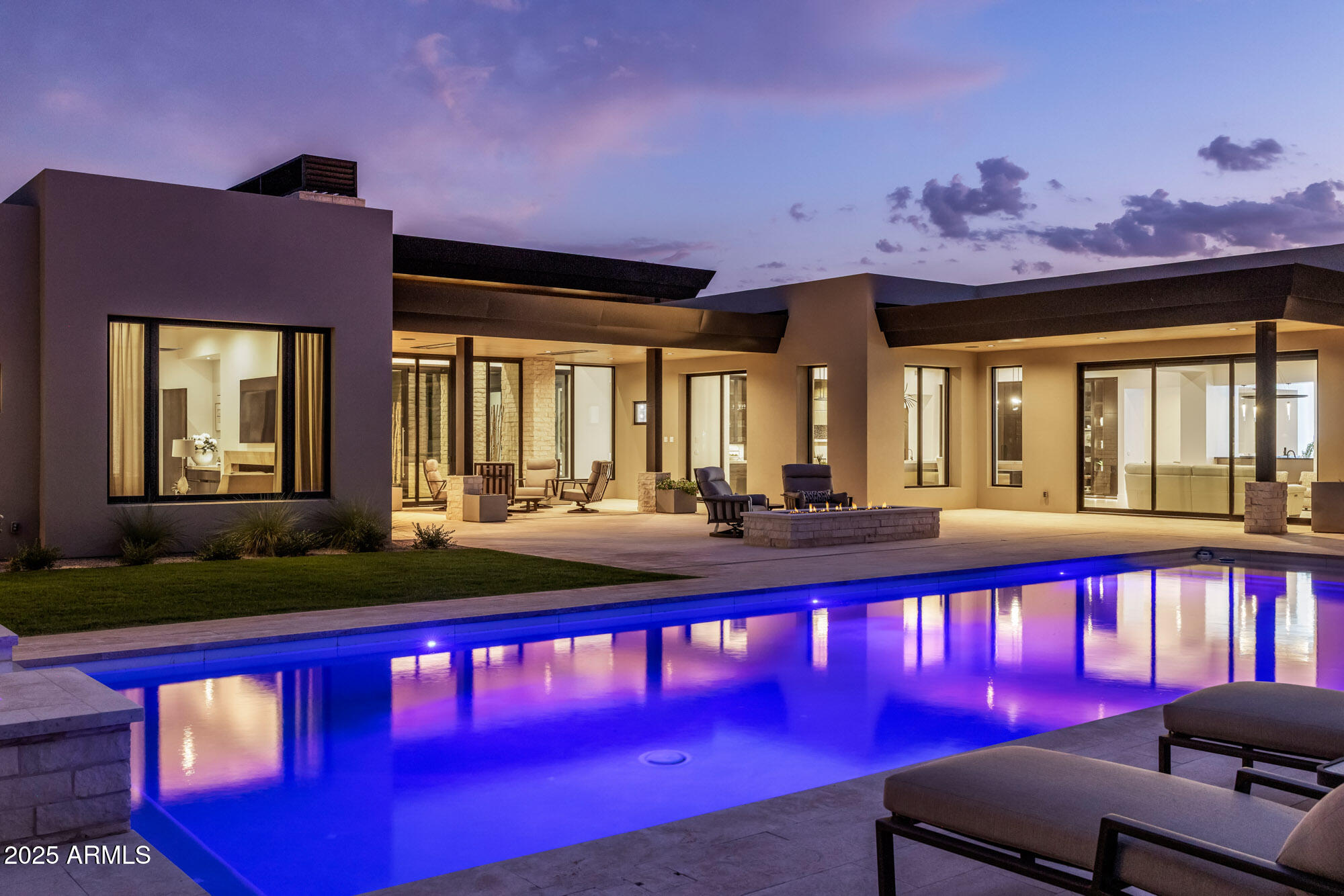 Price Improvement - Offering an unmatched value in the heart of Paradise Valley, this contemporary estate by Sonora West Development is now priced  below comparable neighboring listings. Delivering a rare blend of modern architecture and privacy on nearly one acre, the property features a 5,595 sq ft main residence plus a 969 sq ft detached guest house--a luxury ''bonus'' rarely found at this price point.
Inside, clean lines and warm materials frame generous living spaces, anchored by a chef's kitchen with Sub-Zero and Wolf appliances. The primary suite offers a serene escape with dual vanities, soaking tub, and fireplace, while whole-home Control4 automation ensures modern convenience. The backyard serves as a private resort with a heated pool, spa, and built-in BBQ, ramada, fire pit, and built-in BBQ, surrounded by desert landscape. A circular drive with water-feature courtyard sets a striking first impression, while the gated 4-car garage ensures privacy. Crafted by Sonora West Development, this residence offers estate-scale living with the rare convenience of being walkable to acclaimed restaurants and boutiques in Paradise Valley's most sought-after location.