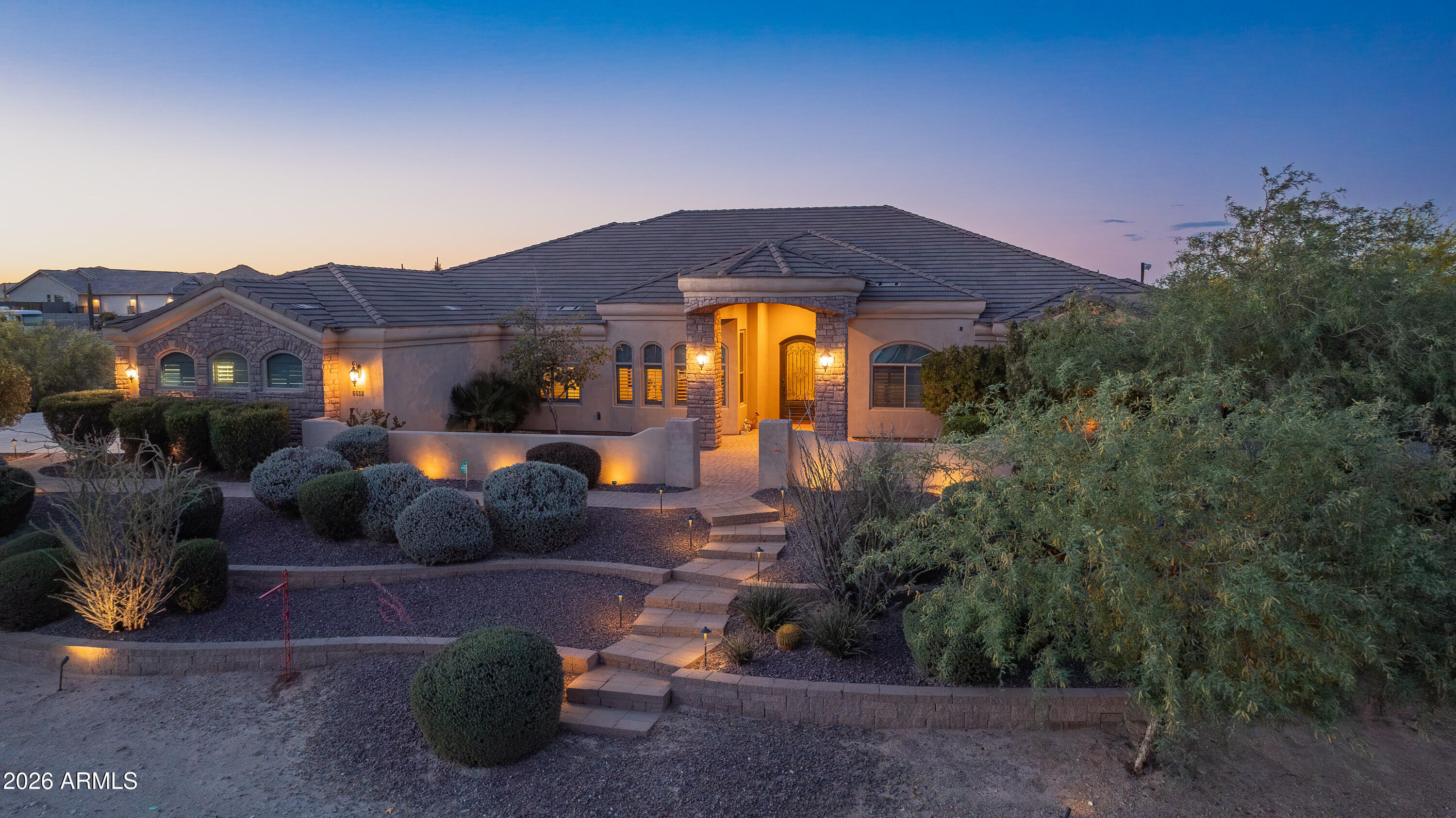 This Spectacular Estate Home offers breathtaking sunset & mountain views that will truly leave you in awe! Nestled on 1.5 acres of wide-open desert in a Luxurious, Private Setting, this stunning horse property at Josiah Trail exudes elegance from the moment you arrive! The expansive front courtyard welcomes you with sweeping vistas, setting the tone for the exceptional craftsmanship & attention to detail found throughout. 
Step into the gourmet chef's kitchen equipped with premium features that flows seamlessly into a grand Great Room anchored by a gas fireplace & alcoves that frame a dramatic wall of windows. You'll overlook the backyard oasis that showcase a sparkling pool, outdoor kitchen, fireplace, gas fire pit, panoramic views of the San Tan Mountains & iconic mature desert cacti! The vast master suite provides direct access to the pool for ultimate relaxation, while a separate guest wing offers privacy with two bedrooms, a Jack-and-Jill bathroom & a versatile media/game room. This home also offers a Central Vacuum system.
The backyard is a true desert oasis with a stunning 22,000-gallon free-form heated pebble-tech pool with an automatic filtering system, autofill, waterfall feature & slide. Also, a wood burning firepit paired with an additional waterfall & pond. Expansive 20'x20' Ramada featuring an outdoor kitchen, ceiling fans & sun-blocking shades. The covered back patio is accessible from the great room, media/game room, pool bath & master suite complete with speaker wiring & TV ready. 
Mature landscaping with an in-ground irrigation system enhances the fully fenced private yard with partial wrought iron for unobstructed desert views. Additional conveniences include RV parking with a large RV gate on the east side, plus a generous front courtyard.
For added appeal, the home boasts a four-car garage with 10' ceilings, abundant built-in storage cabinets & a dedicated workbench. This Josiah Trail gem combines luxurious indoor living with an unparalleled outdoor retreat ideal for those seeking privacy, space for horses & unforgettable Arizona desert beauty! This is your new home in the Countryside of the San Tans! Come Home to the Country, You'll Fall In Love With The San Tans, Too!