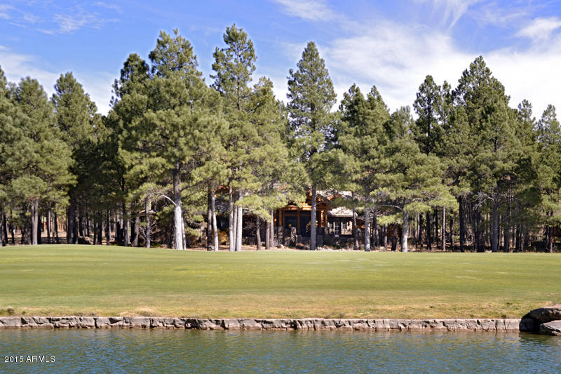 COMPS ONLY- Spectacular custom Log Home nestled on a 1.65 acre corner lot with panoramic golf course and lake views!  Critical attention to detail was given to the thought, construction and finishes of this masterpiece.  The home includes oversized logs throughout, dramatic features such as 7 fireplaces, 2 laundry rooms, oversized 4-car garage, attached 2 bedroom apartment complete with full kitchen, game room and bar, expansive covered decks with fireplace, built in BBQ, hot tub and views!!  Come experience this one of a kind home in Forest Highlands.
