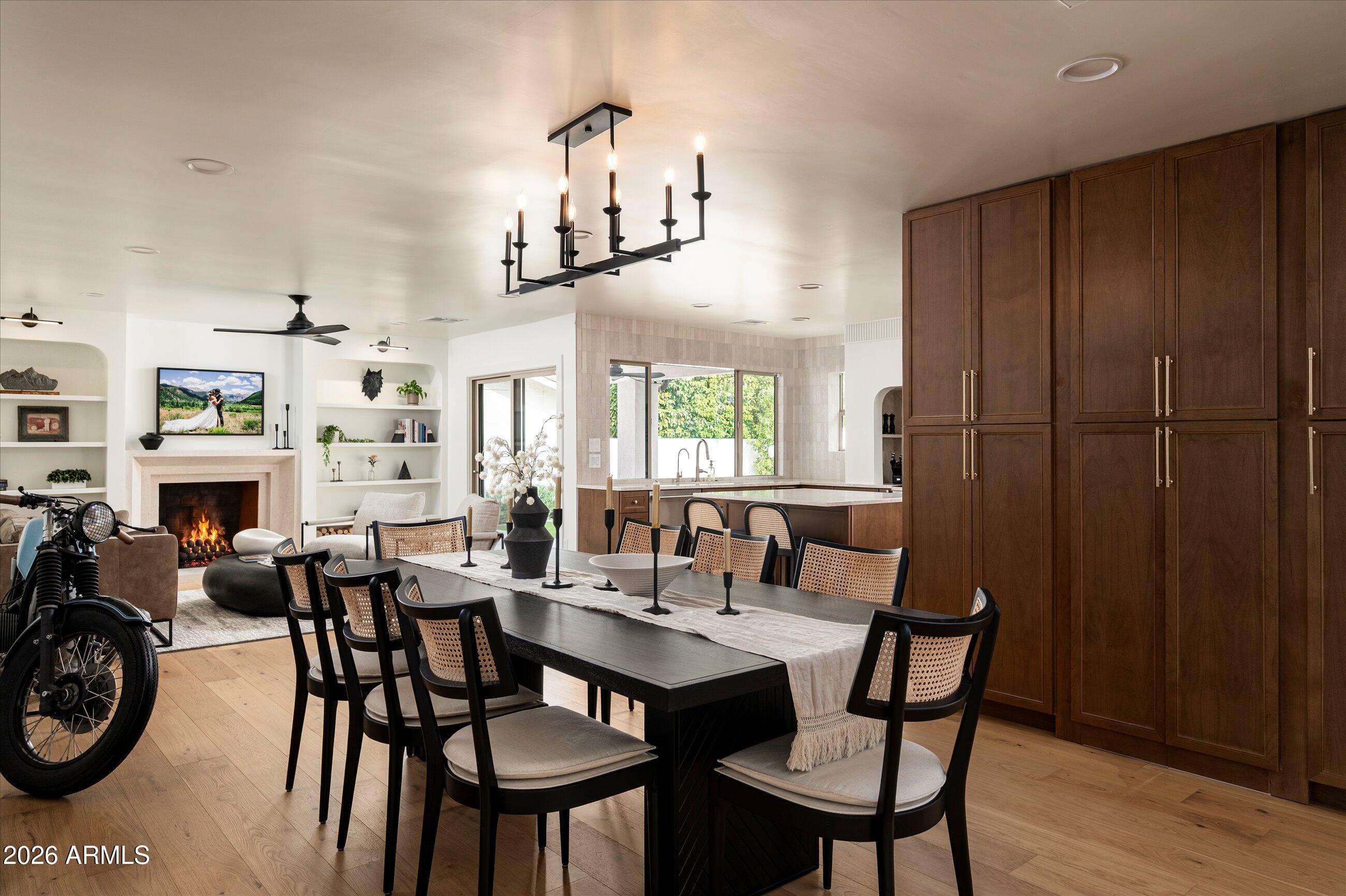 Tucked into a quiet enclave just south of Gainey Ranch, this fully remodeled home has been rebuilt from the studs out with the kind of restraint that shows itself the longer you look. Custom steel French doors open to white oak floors and soaring vaulted ceilings. The chef's kitchen is dressed in SOLLiD cabinetry, Taj Mahal quartzite counters, GE Monogram built-in appliances, and Delta champagne bronze hardware, with a hidden walk-in butler's pantry tucked behind the scenes. The kitchen flows into a family room anchored by a custom limestone fireplace. The primary suite delivers a freestanding tub, walk-in rain shower, double vanities, and an oversized walk-in closet. Outside, a saltwater pebbletec pool, built-in BBQ kitchen, two covered patios, large-format slate, and low-maintenance turf create a private backyard built for year-round living. Major systems are done: new roof, HVAC ducting, water heater, dual-pane windows and doors, RO and whole-home water filtration, sewer cleanout, saltwater pool conversion and equipment, washer and dryer, custom steel gates, ethernet and cable throughout, red cedar garage door, epoxy garage floors, and a new electrical panel ready for a 24/7 cold plunge. Best of all, close to a public easement for the community that allows you to walk to Gainey Village, the Grand Hyatt, and the Shops at Gainey Village.