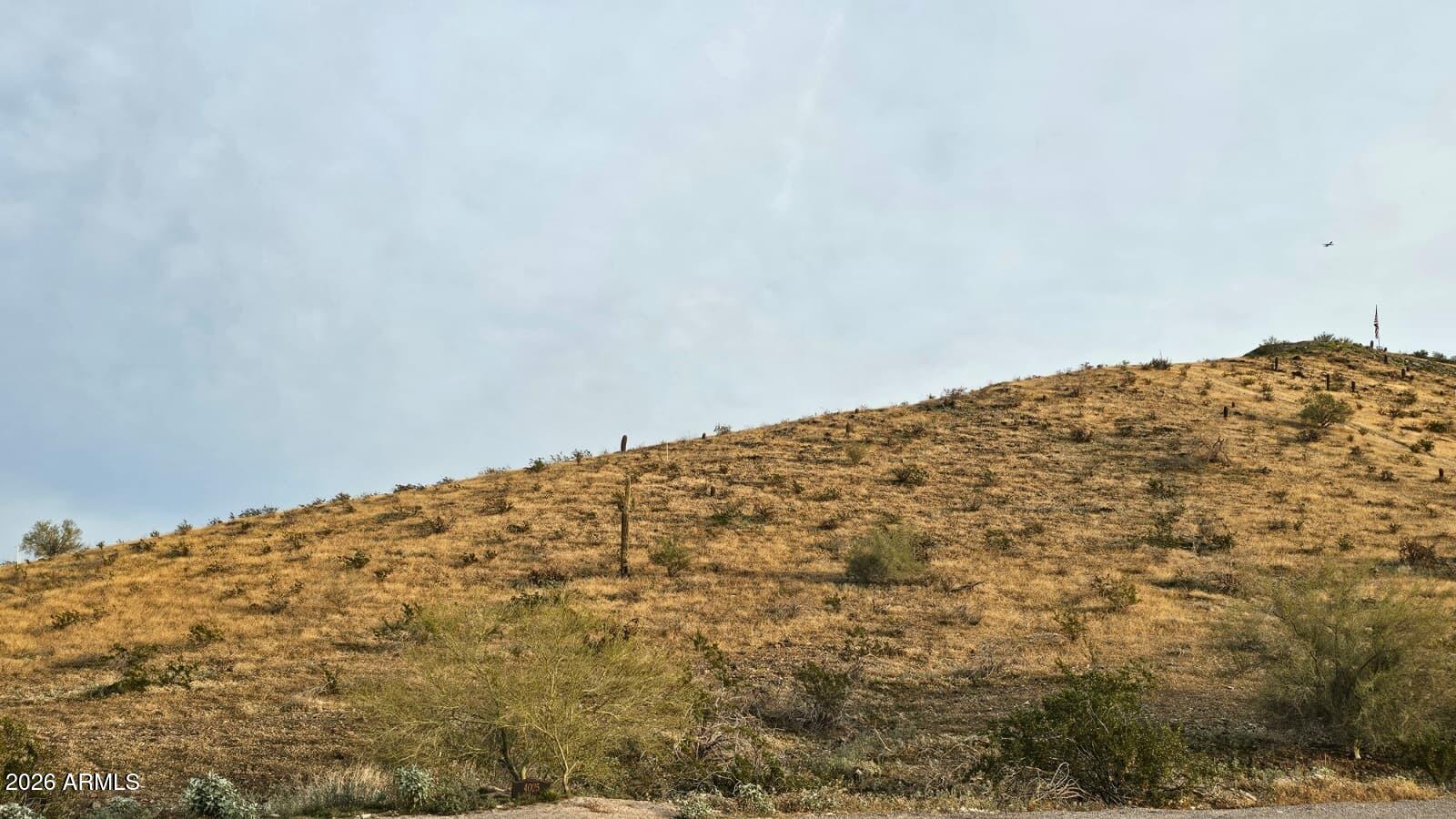 An exceptional opportunity to own one of Laveen's most coveted hillside homesites, offering breathtaking 180-degree panoramic views of the city skyline and surrounding mountain ranges. Perfectly positioned just minutes from the Loop 202, this elevated lot delivers the ideal balance of convenience, privacy, and serenity.

Enjoy unforgettable sunrises, vibrant desert sunsets, and twinkling city lights all from the future site of your custom dream home. The natural elevation enhances both privacy and view corridors, creating a truly special setting for a luxury residence designed to maximize views in every direction.

With limited availability of premium view lots in this area, opportunities like this are increasingly rare. There are few comparable properties offering this combination