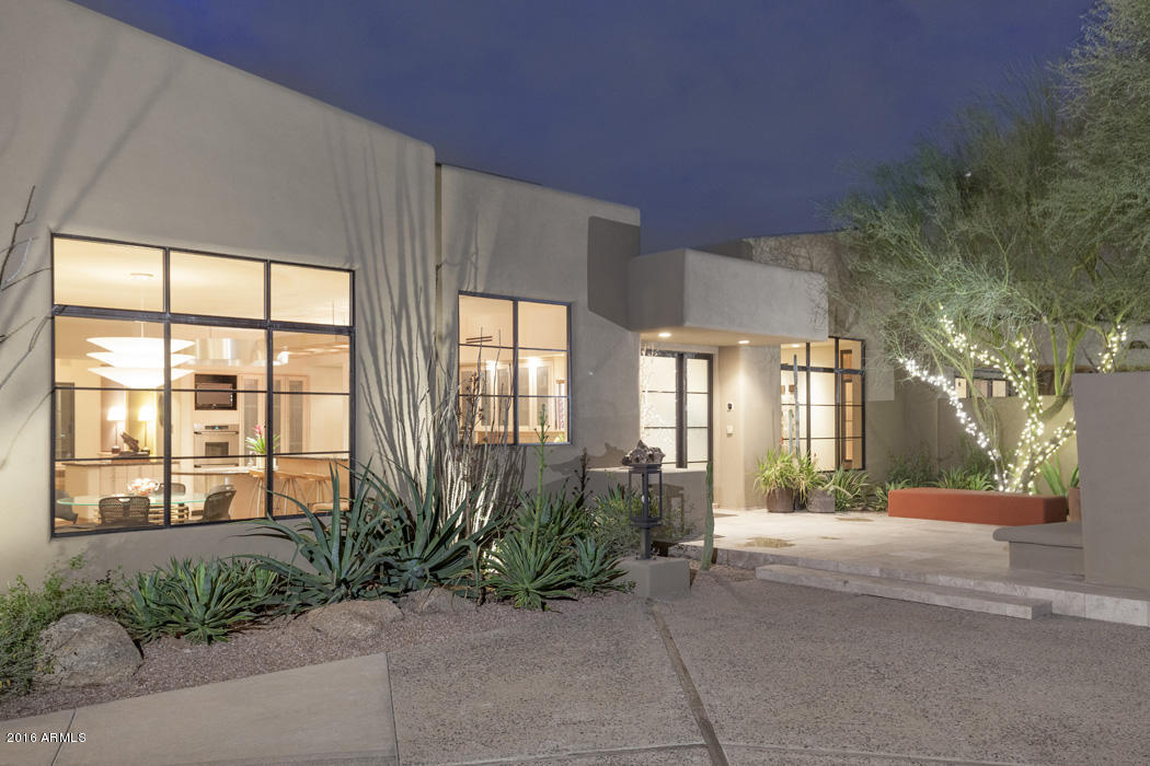 First time on the market, this timeless and tranquil home was designed for gracious living and effortless entertaining for groups large or small.  A front courtyard with fireplace is visible from glass walls in the dining room.  The living room is very large and bright with views to the south overlooking a sparkling pool and twinkling city lights beyond.  The kitchen is contemporary, clean, and designed for those who love to cook. Enjoy a beautiful adjoining breakfast room with fabulous mountain views.   An office with highest quality built-ins features views to the south.  The master bedroom is a Zen retreat with a luxurious master bath showcasing fine fixtures.  Additionally, a children’s wing with a pair of matching ensuite bedrooms and separate den as well as a private guest suite.