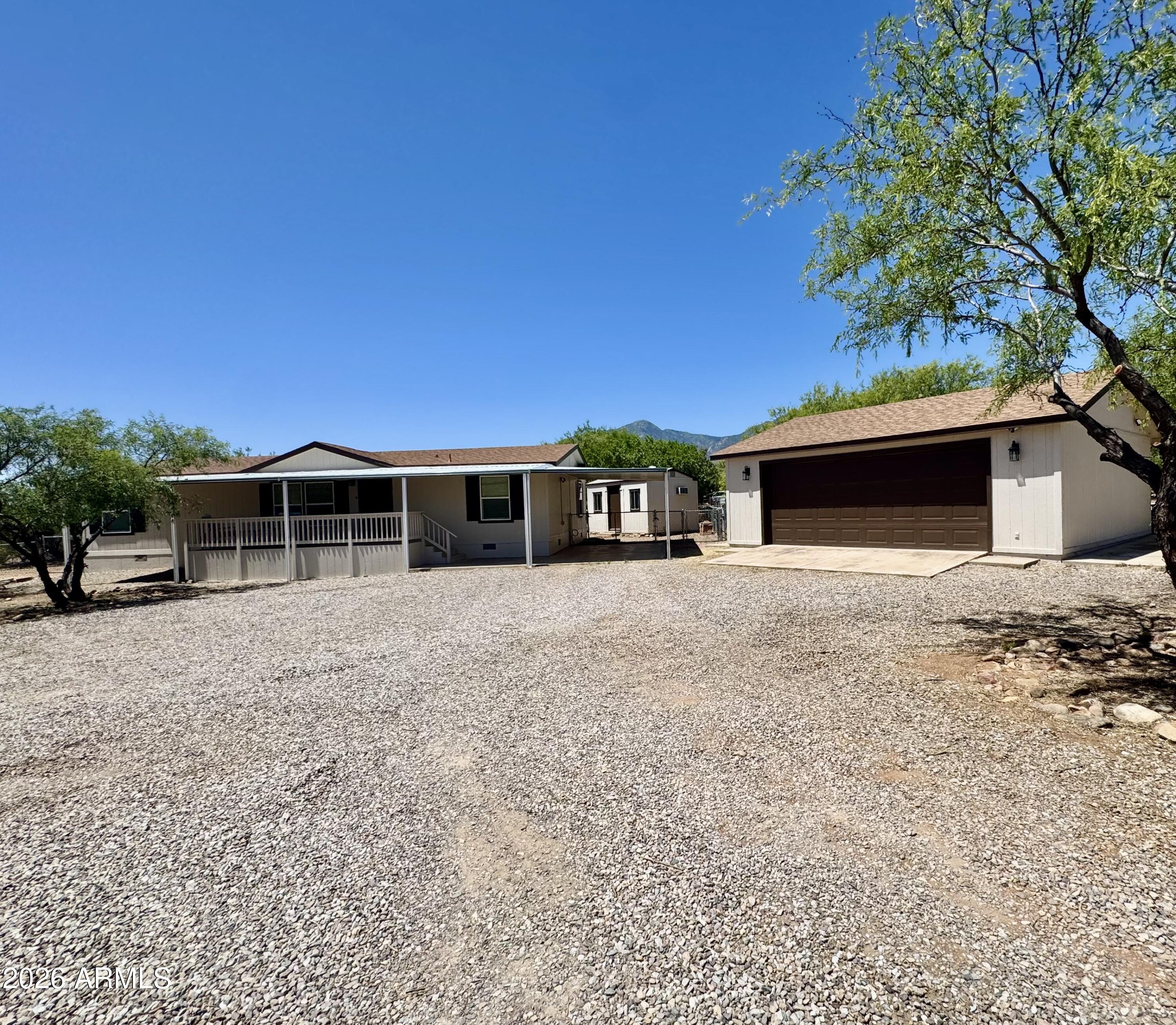 Stunningly remodeled home with mountain view. New windows, Roof, Flooring , Bathrooms , Kitchen Appliances and Paint inside and out. Attached carport, detached two car plus garage. Air conditioned shed. Gated with the whole property fenced .
