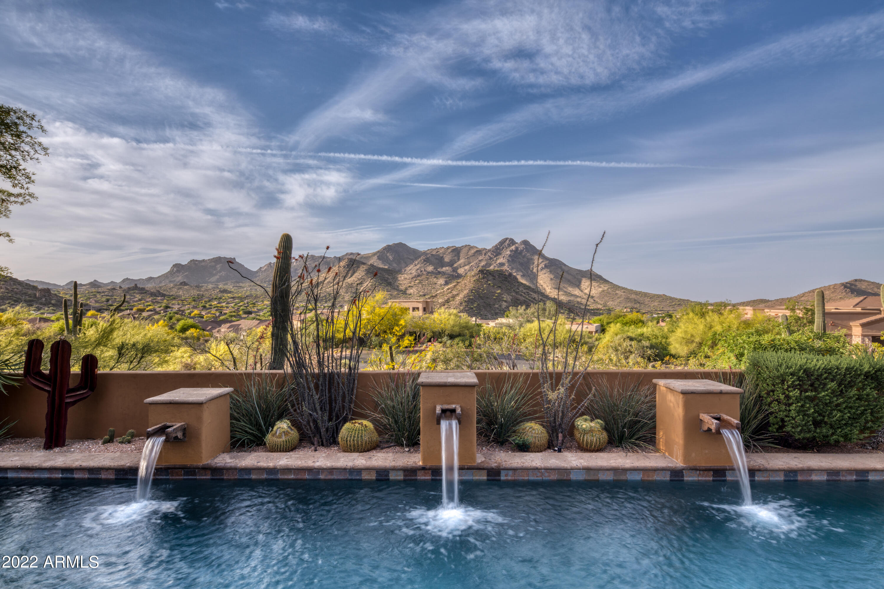 Remodeled in 2019, this stunning ''modern hacienda'' lends itself naturally to the desert landscape that is Troon Mountain Estates.  With unobstructed views of the McDowell Mountains,  the Four Sisters, and beyond; this elegantly crafted home offers upscale comfort and a sense of privacy all while being conveniently located in North Scottsdale.  Finest finishes include hand hewn beams, gorgeous wood floors, Heritage Windows, custom cabinetry and hardware; as well as new plumbing fixtures and fittings.  The thoughtfully designed floor plan includes master suite, an additional en-suite bedroom, office with lovely built-ins, great room and kitchen downstairs.  Upstairs are three additional bedrooms and a game room/media room featuring two balconies to take in the majestic views.