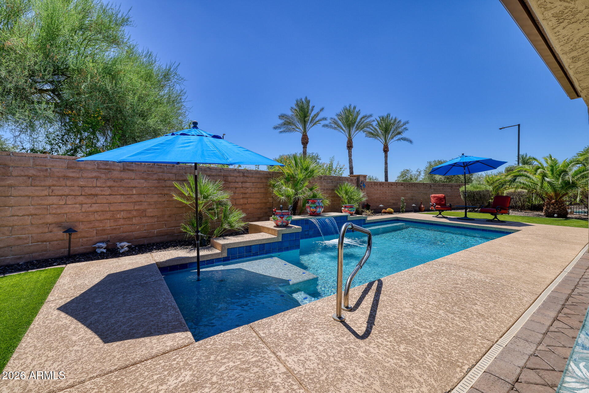 Truly BEYOND BEAUTIFUL this exquisite popular Civitas model with owned SOLAR is perfect for those looking to live a life of cool, calm and quiet luxury. This home is nestled on a generous 11,000+ square foot lot with a HEATED POOL, fire-pit, and an abundance of mature landscaping. Fall in love when you step out of your car to view the pristine desert landscaping and enter into the private, lush courtyard and then step across the threshold to the easy flowing light and bright floor plan that flows from room to room and seamlessly connects the indoor and outdoor living.  Steps away, the sensational kitchen shows off  glistening Taj  Mahal Granite Counters, stainless steel appliances and a generous island, ideal for showing off your culinary talents. The Den or home office is dressed to impress with its unique office space, book shelves, and open sitting space. Both sleeping quarters are quite spacious, especially the primary suite, home to a lavish bath with full size shower, his and her sinks, a make-up counter and a walk in closet. Not to be forgotten is the oversized Garage with built-in-cabinets, epoxy floors and a metal storage rack. This home is located in the amenity-rich 55+ active adult community of Trilogy at Vistancia. Golf is just one of the many features offered here. Also included are 2  luxurious clubhouses, 2resort-style pools, a fitness center, and pickleball, tennis, and bocce ball courts as well as countless classes and clubs. Just imaginegetting everything you want in a home plus living in the beautiful gated community of Trilogy at Vistancia.