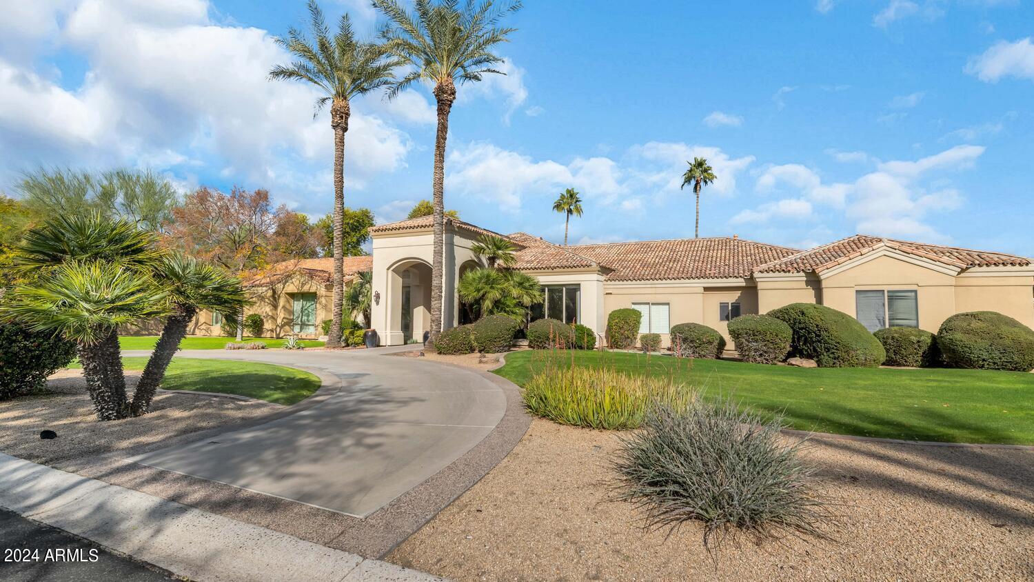 This Paradise Valley estate is super luxurious. A grand entrance leads to the beautiful kitchen with double islands, double ovens and double dishwashers, home office with custom cabinetry and interior french doors creating privacy, seven bedrooms, all ensuite, 9 bathrooms, and a guest casita that has a full kitchen and separate bedroom. The living room, family room and dining room are all big enough for large gatherings, yet very comfortable for a smaller crowd. Some of the home's unique finishes include a 1,450 bottle wine room, exposed wood beams, custom brick barrel ceiling, floor to ceiling picture windows and multiple fireplaces. Sitting on a sprawling one-acre lot, it has a lovely heated pool, spa, putting green, fantastic covered patio with built-in barbecue and a large grassy yard. This is a delightful residence in a fantastic location!